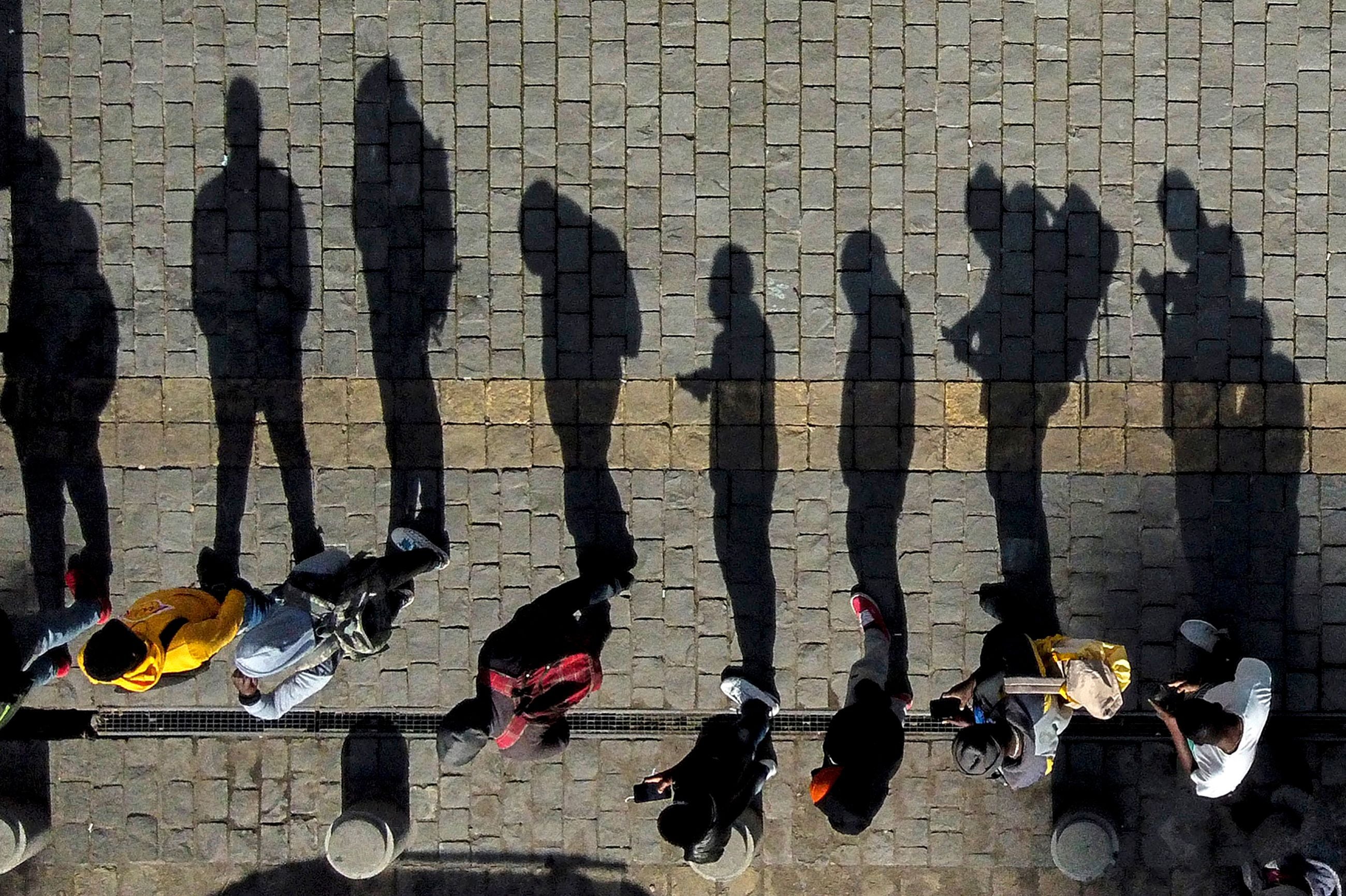 People queue up to enter a branch of the pension funds office in Santiago