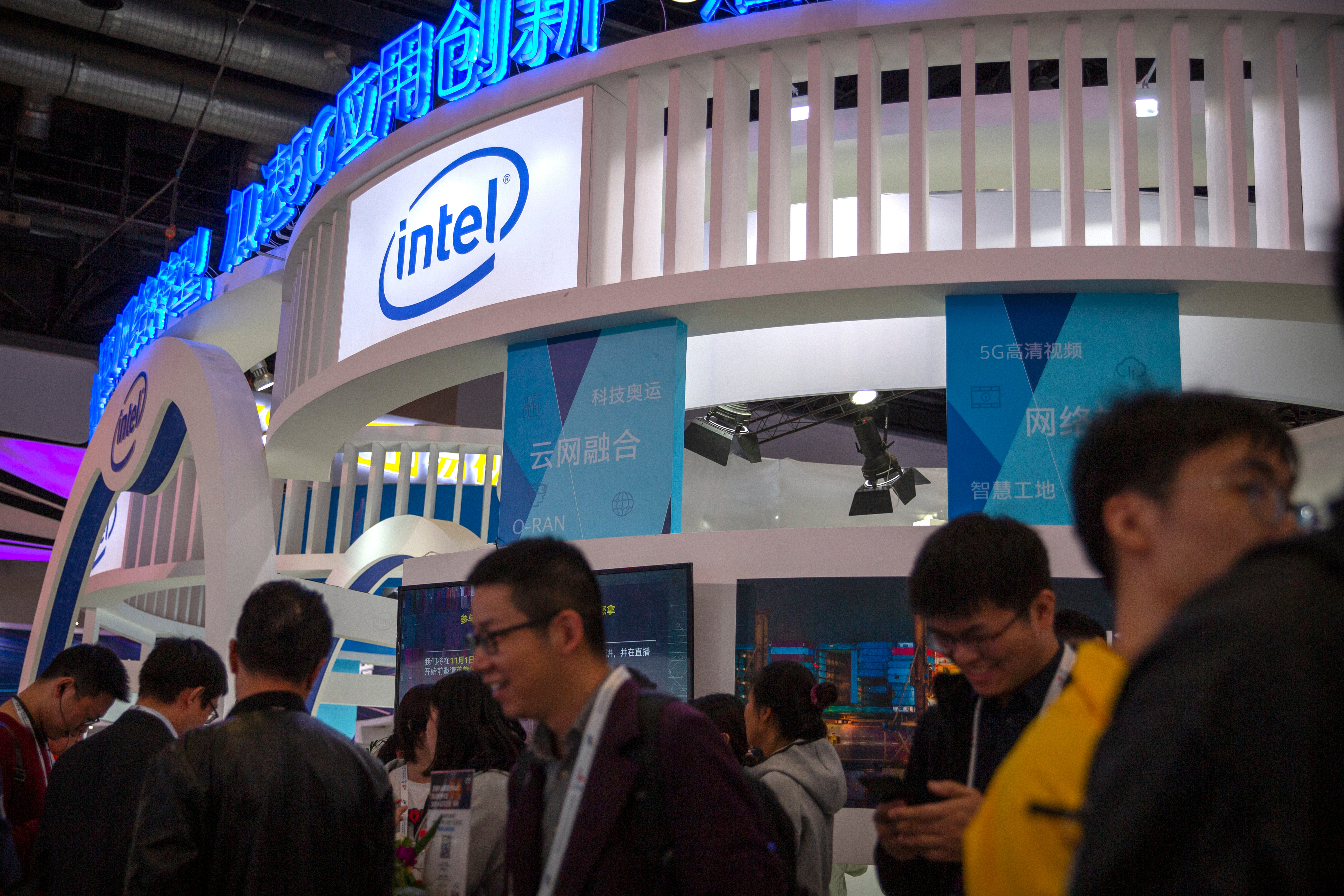 File: Attendees walk past a booth from chipmaker Intel at the PT Expo in Beijing on Oct. 31, 2019