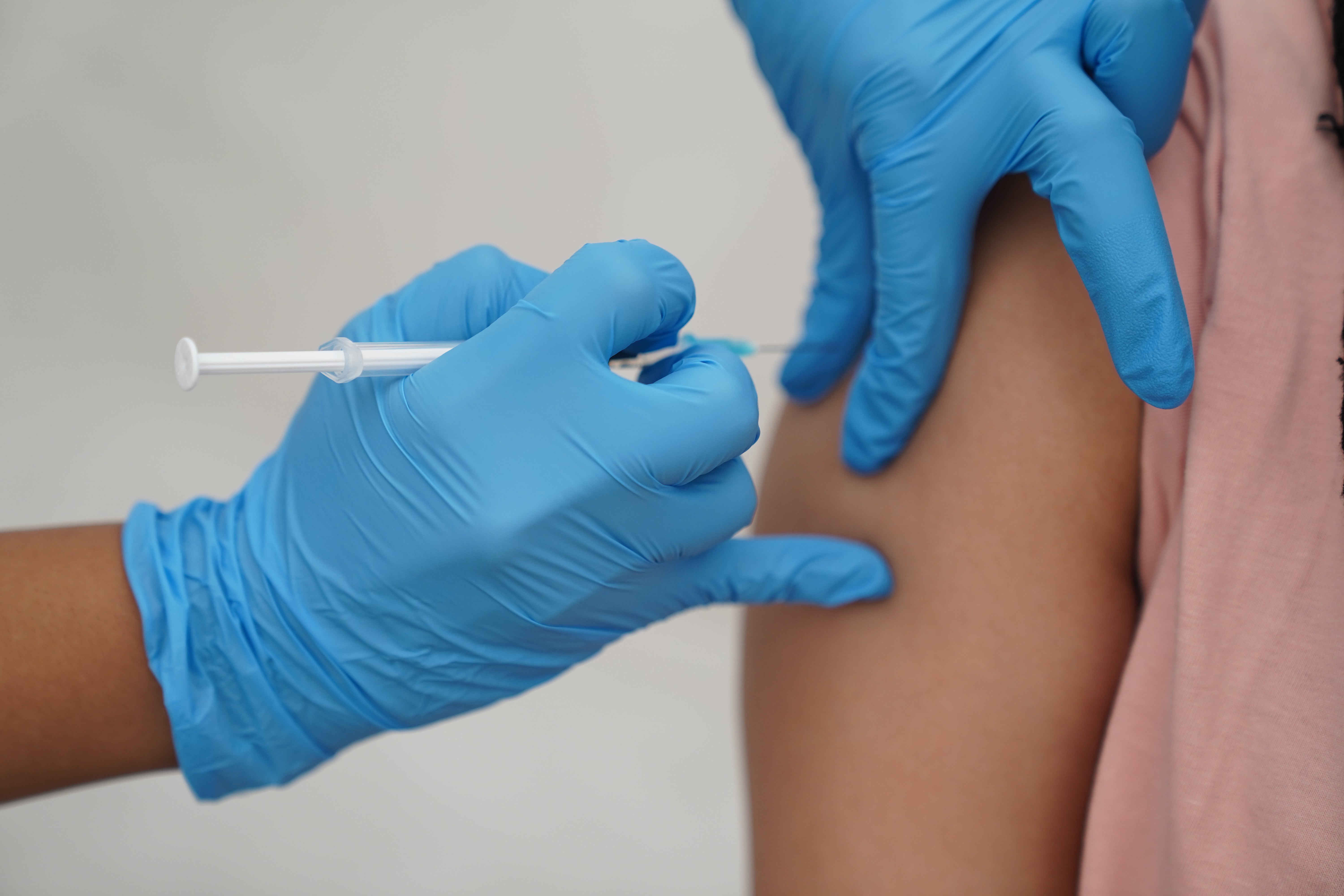 A woman receives a Covid-19 jab (Kirsty O’Connor/PA)