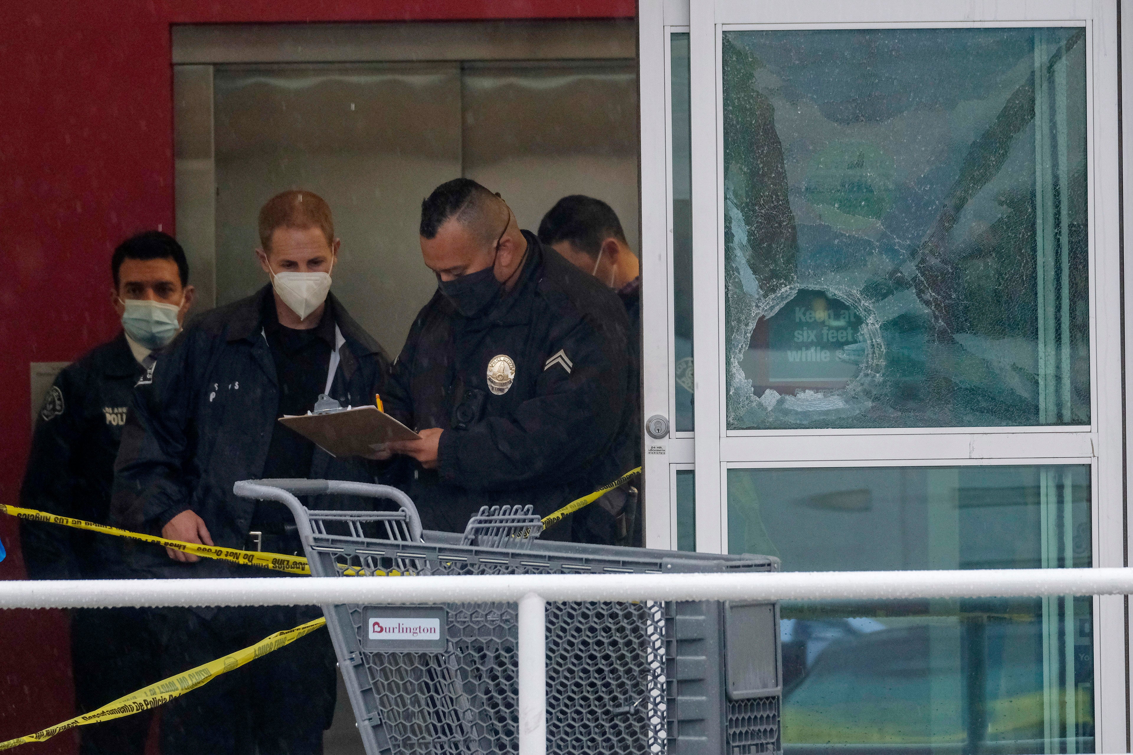 Police are pictured at the scene of last week’s deadly shooting at a Burlington store