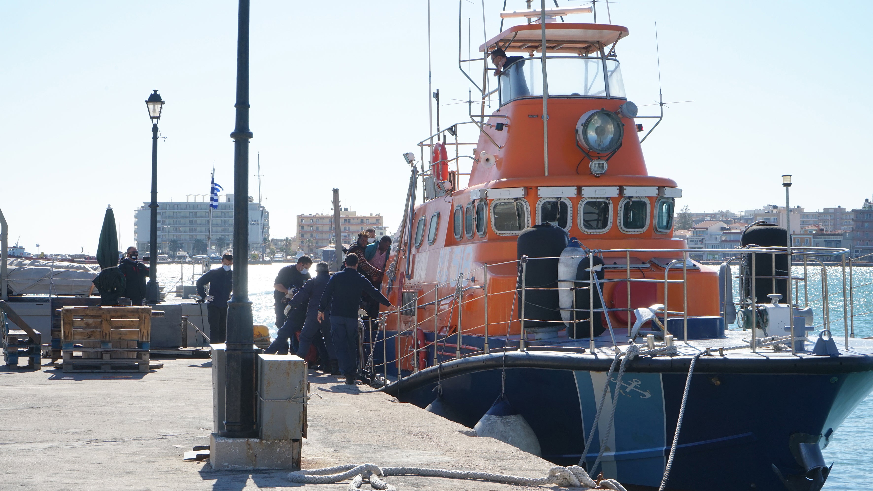 Rescued migrants disembark a coastguard boat at Chios Island, Greece, in October