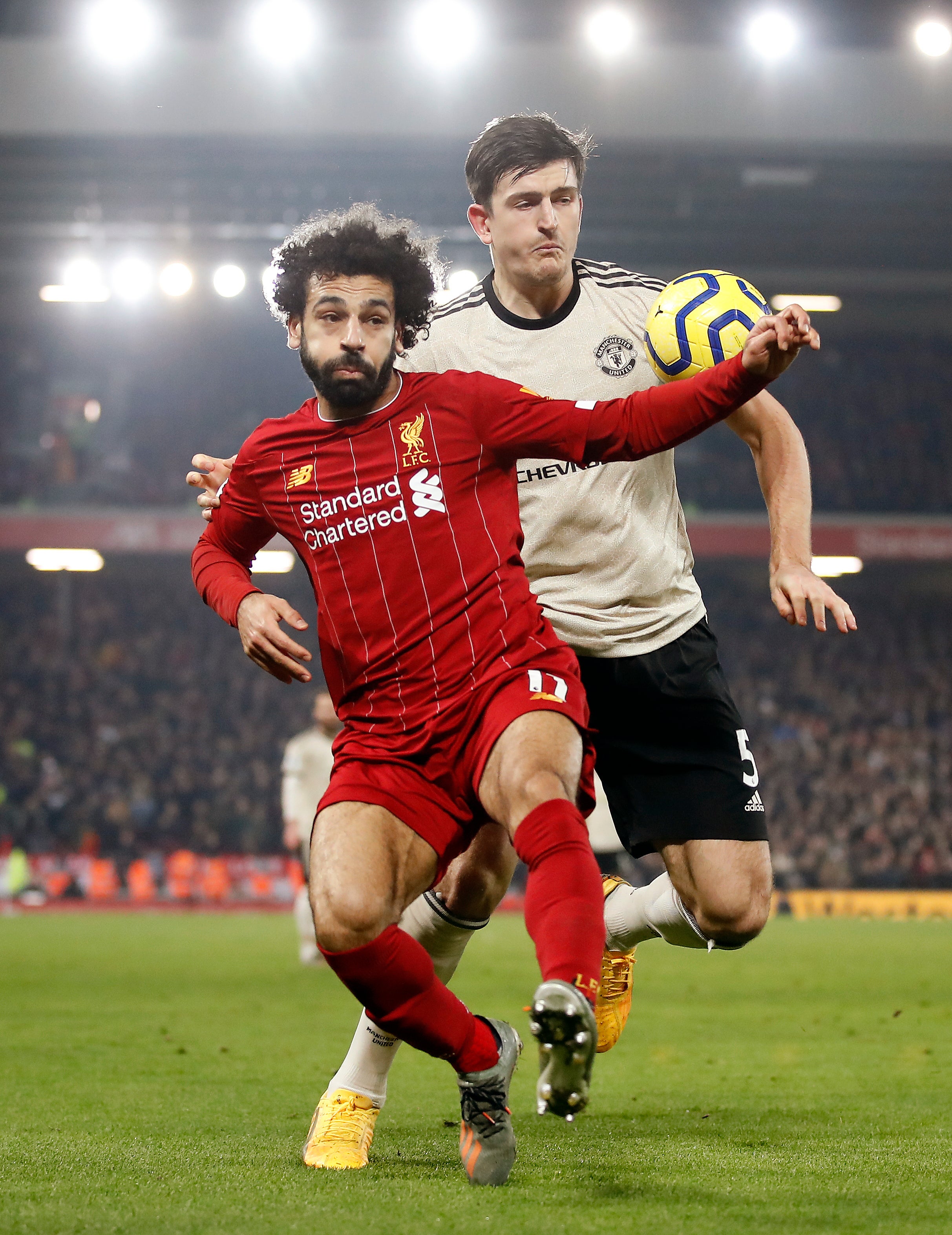 Liverpool’s Mohamed Salah (left) and Manchester United’s Harry Maguire battle for the ball (Martin Rickett/PA).