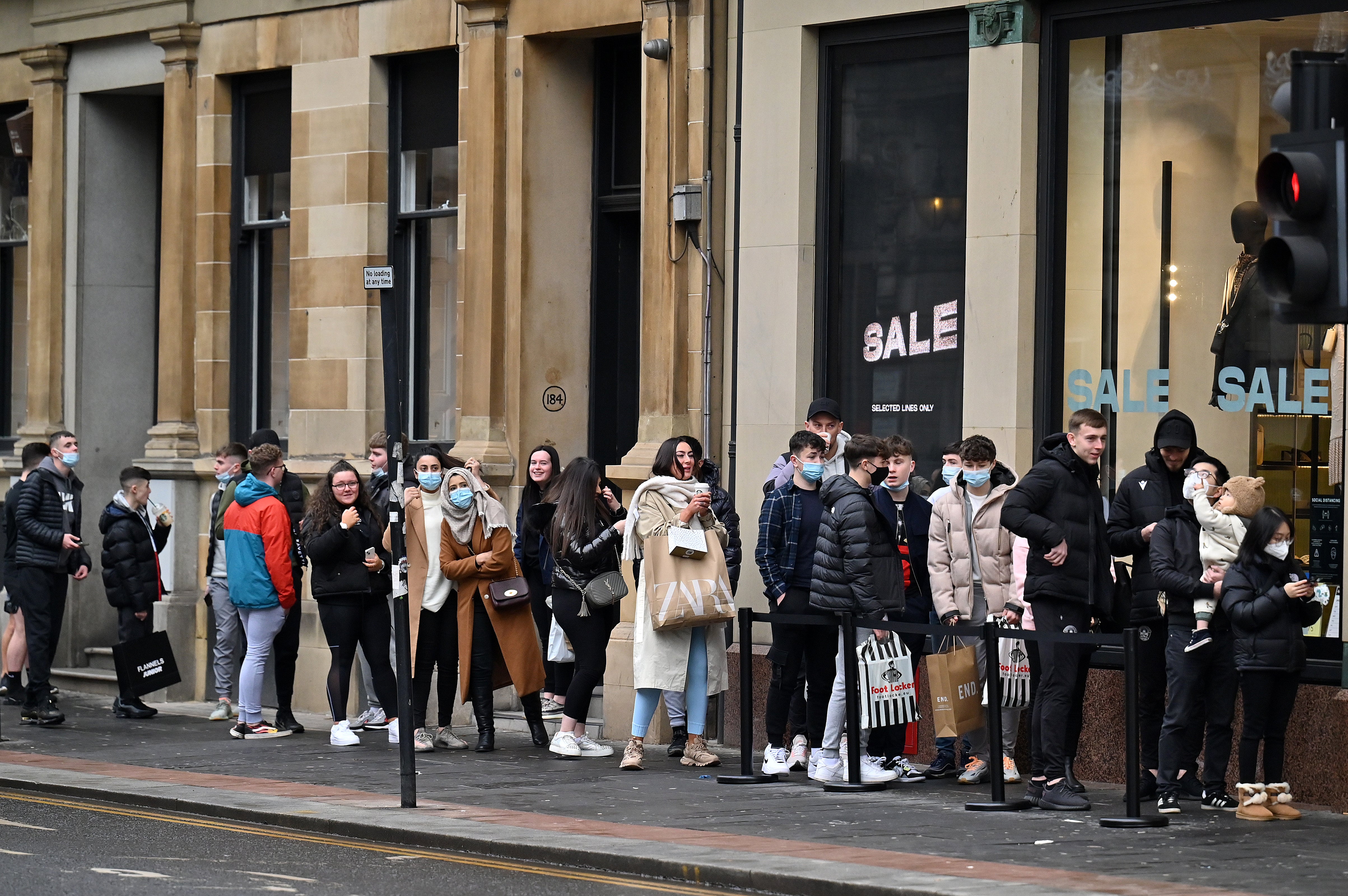 Despite Covid restrictions across Scotland, members of the public still queued up outside shops in Glasgow