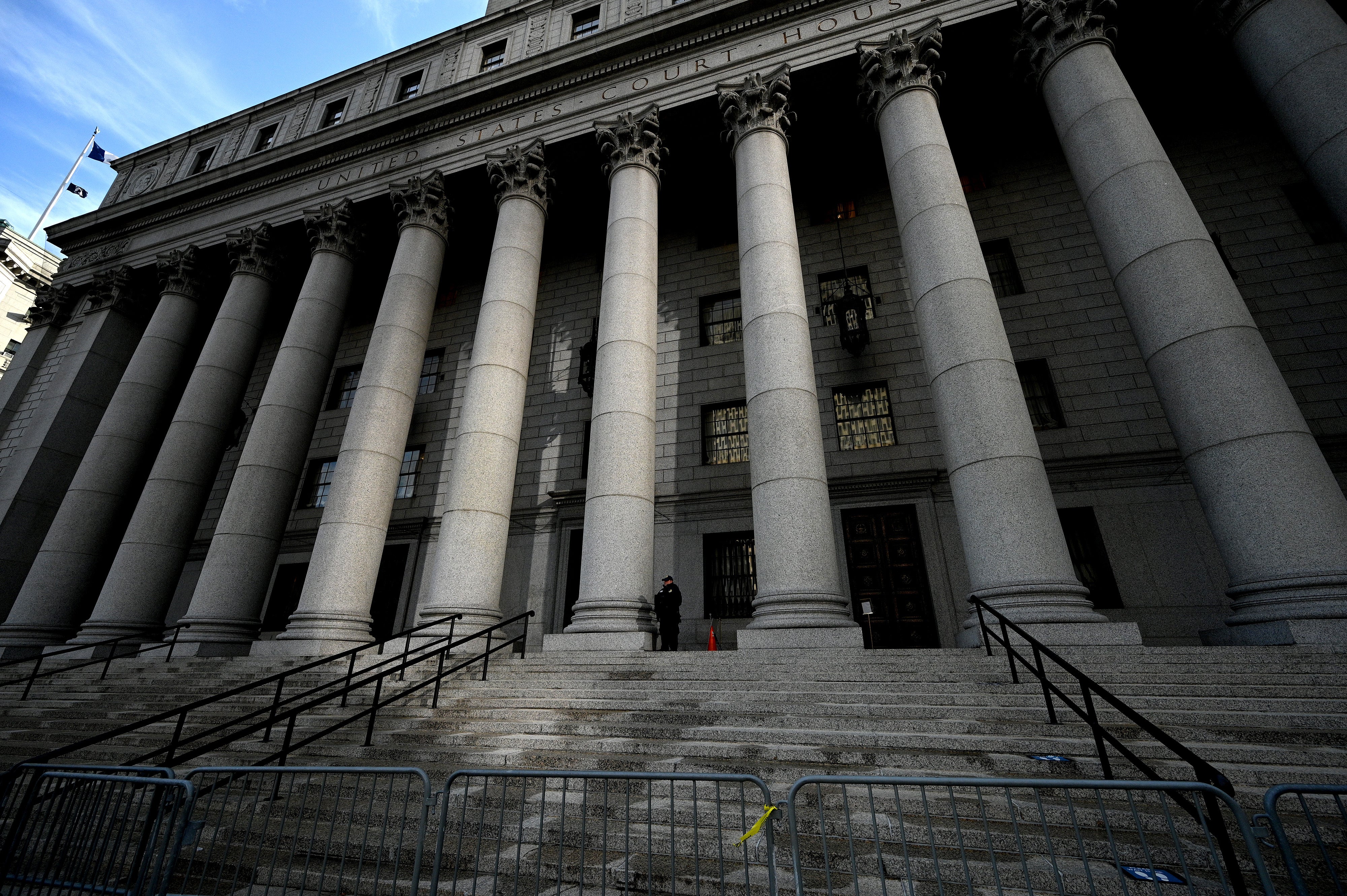 A courthouse police officer stands at the top of the steps to the New York City Federal Courthouse in the Southern District of New York (Anthony Behar/AP)