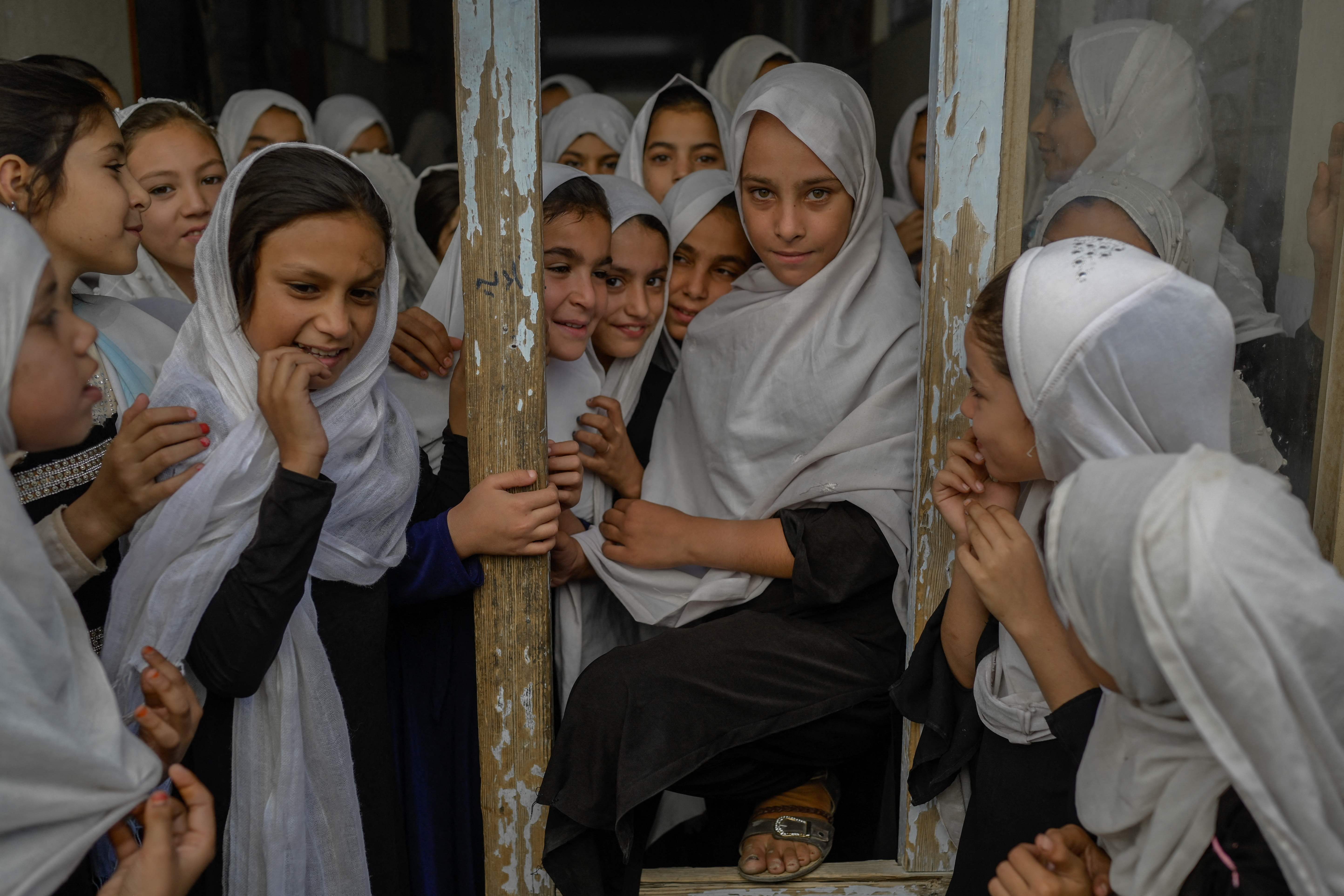 Afghan girls are pictured as they step out of their respective classes, in a school in Kandahar