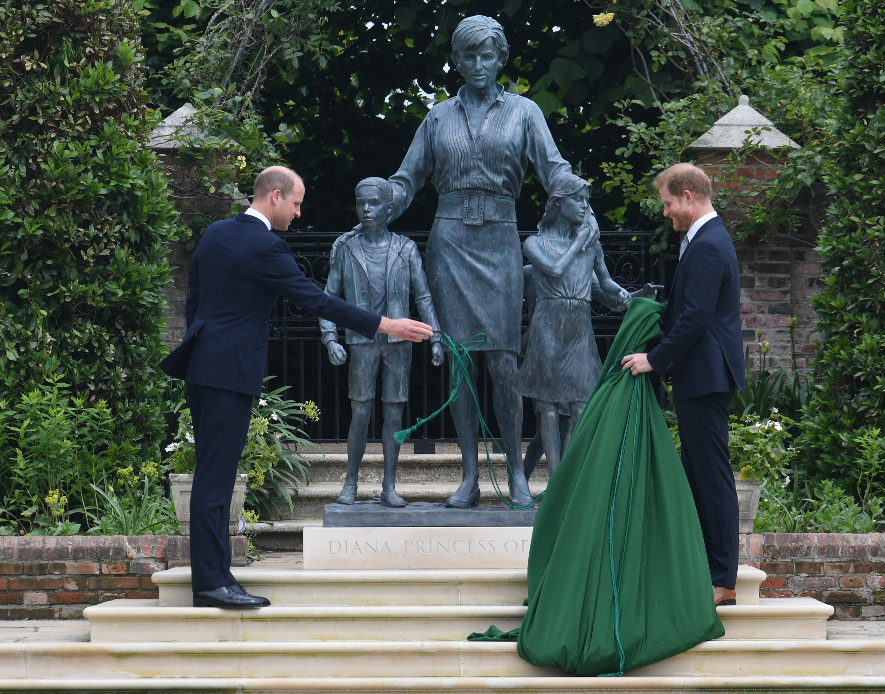 The Duke of Cambridge and Duke of Sussex unveiling a statue they commissioned of their mother Diana