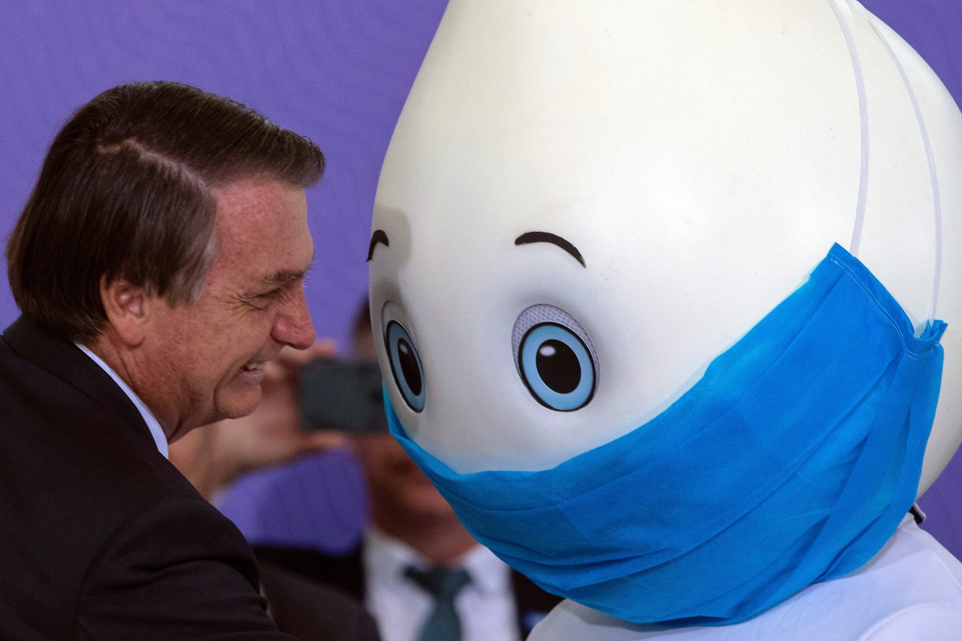 Bolsonaro poses with the Covid vaccine mascot Ze Gotinha in Brasilia