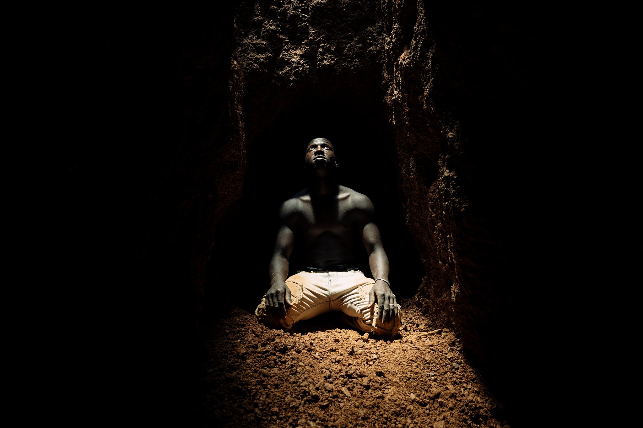 A miner at the bottom of the deep shaft catches the last glimpse of daylight before retreating along a tunnel which extends as far as 200 metres