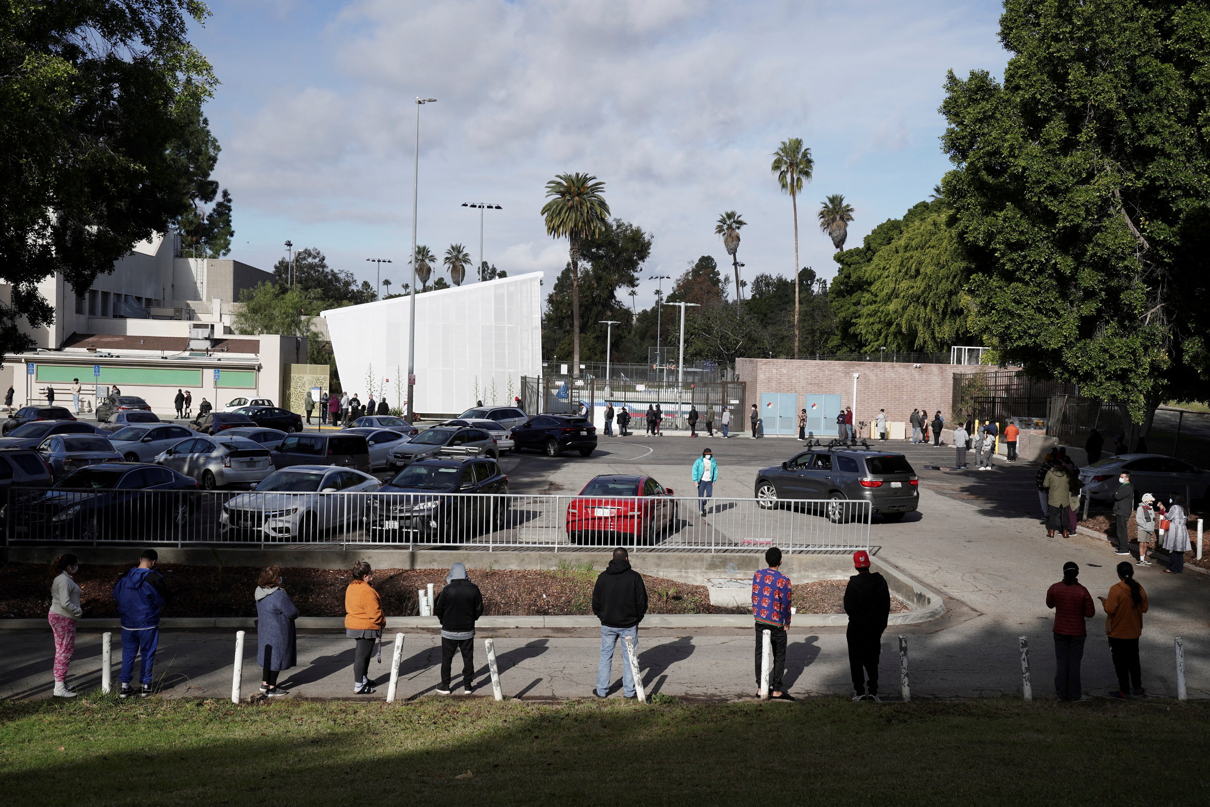 People queue in line at a coronavirus disease (COVID-19) testing site, as the Omicron variant threatens to increase case numbers after the Christmas holiday break, in the Lincoln Heights neighborhood of Los Angeles, California, U.S. December 27, 2021.