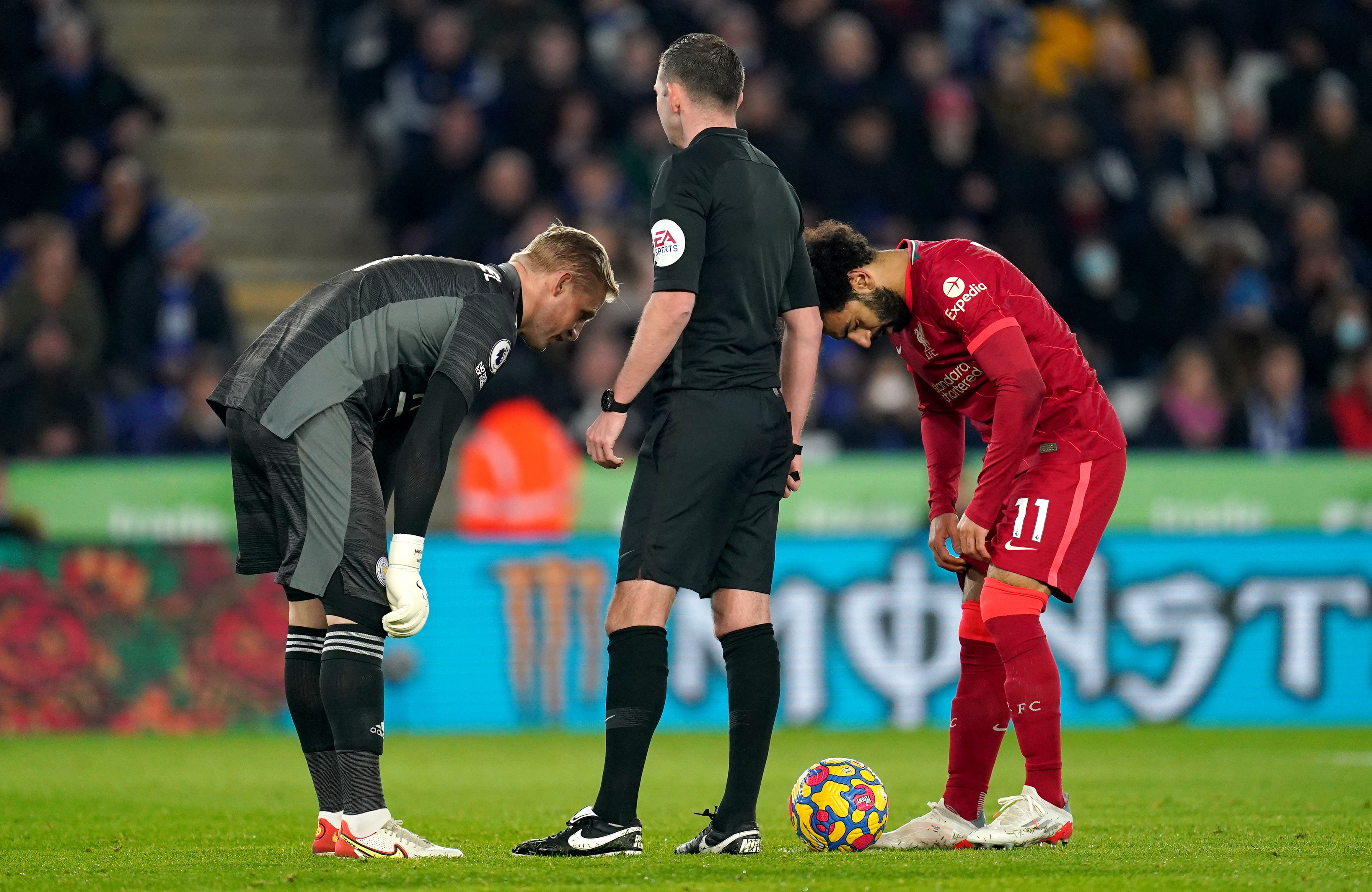 Kasper Schmeichel, left. speaks to Mohamed Salah before saving the Liverpool forward’s penalty (Nick Potts/PA)