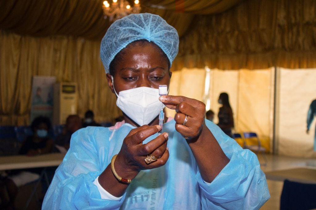 A nurse administers a vaccine in Angola – only 7.5 per cent of the African continent is fully vaccinated