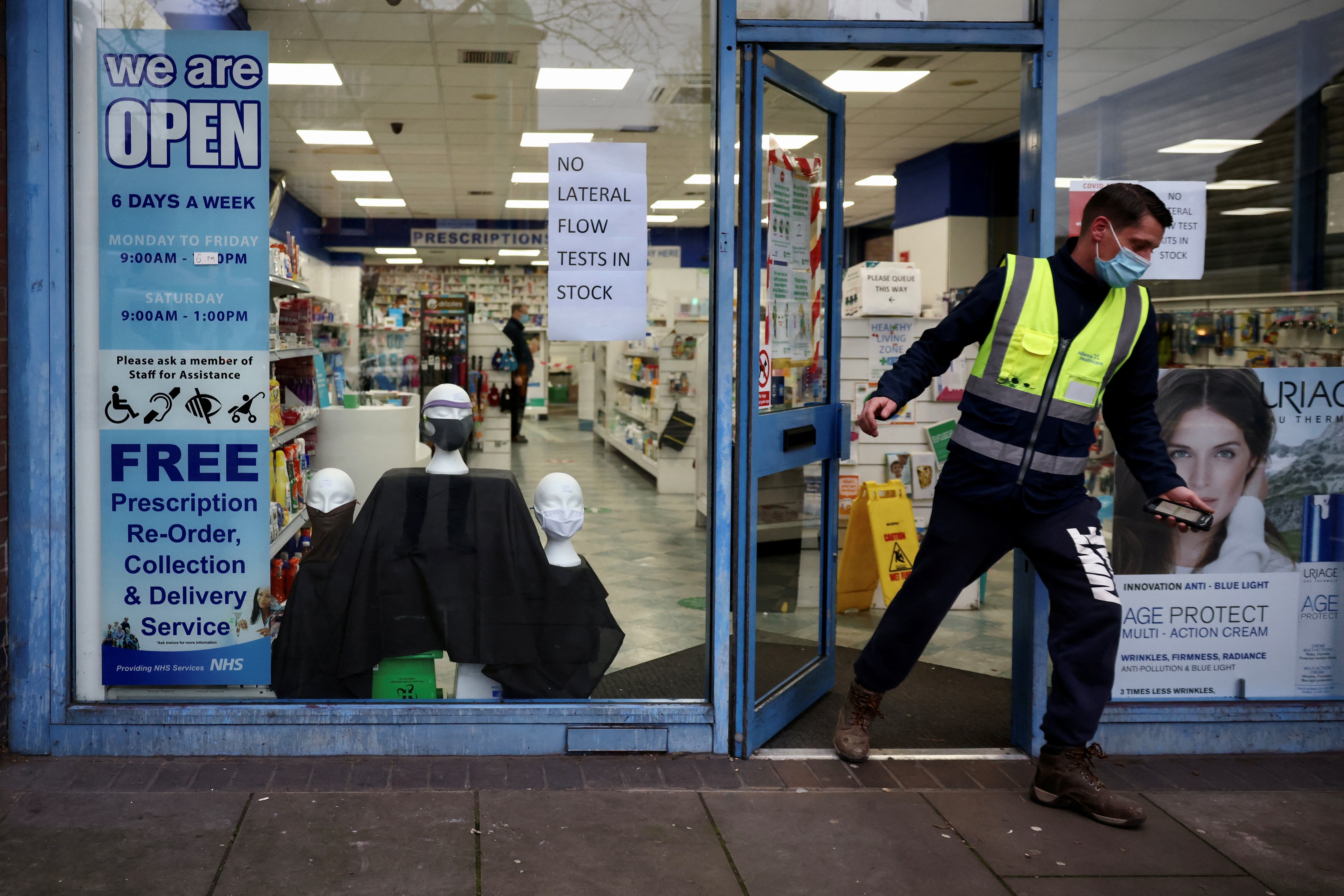 A sign informing customers that lateral flow tests are out of stock is seen at a pharmacy during coronavirus