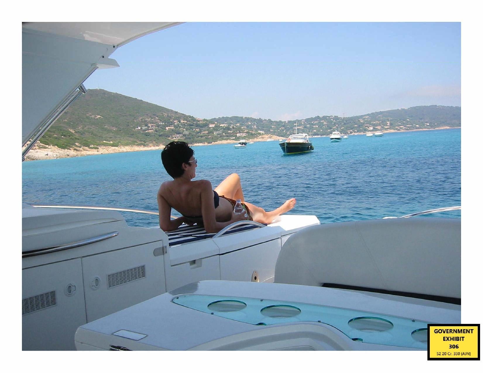 Ghislaine Maxwell sunbathes on a yacht in a photo issued by the US Department of Justice (PA)