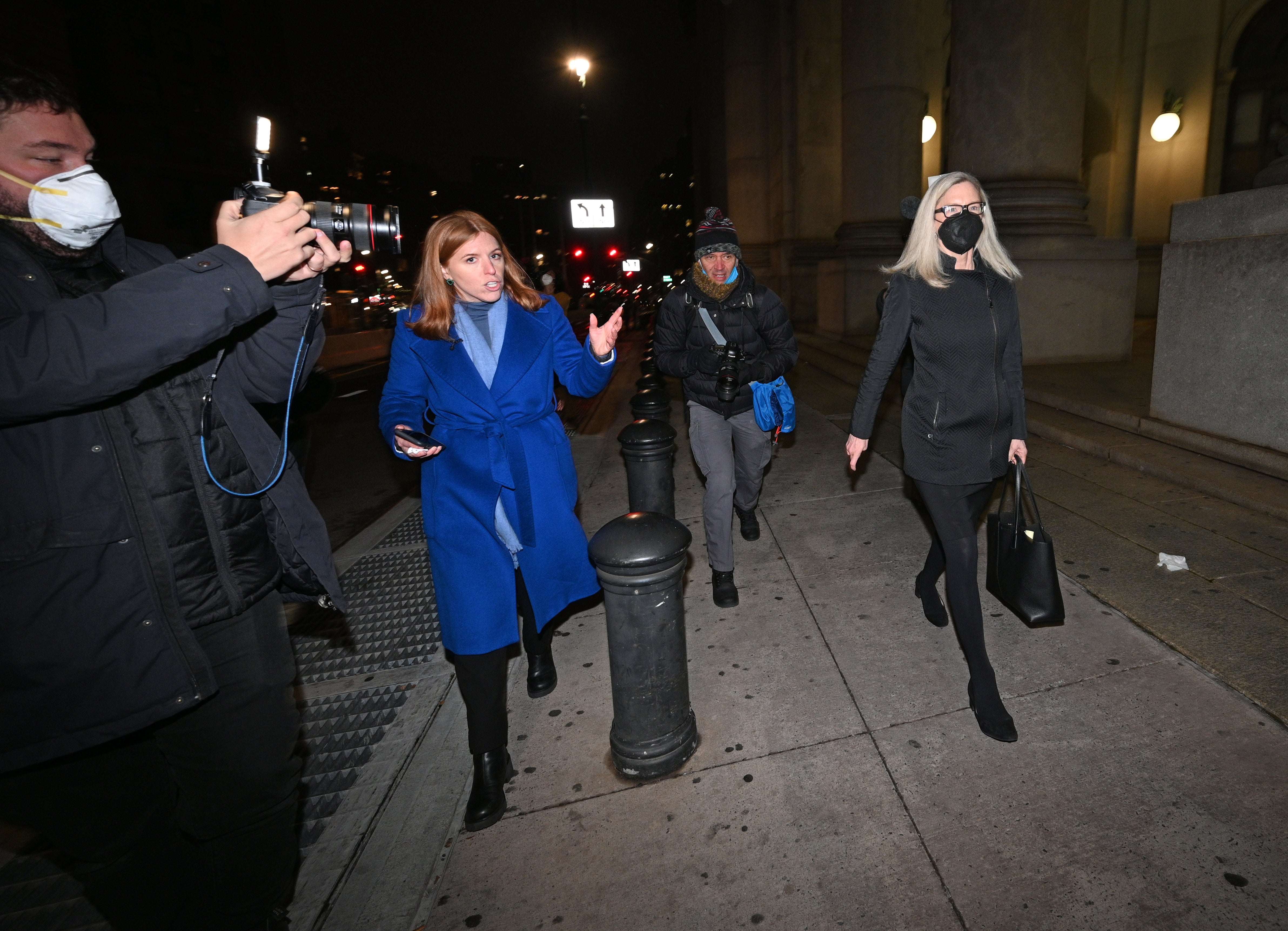 A journalist questions defence lawyer Laura Menninger (right) as she leaves the federal courthouse in New York (AP)