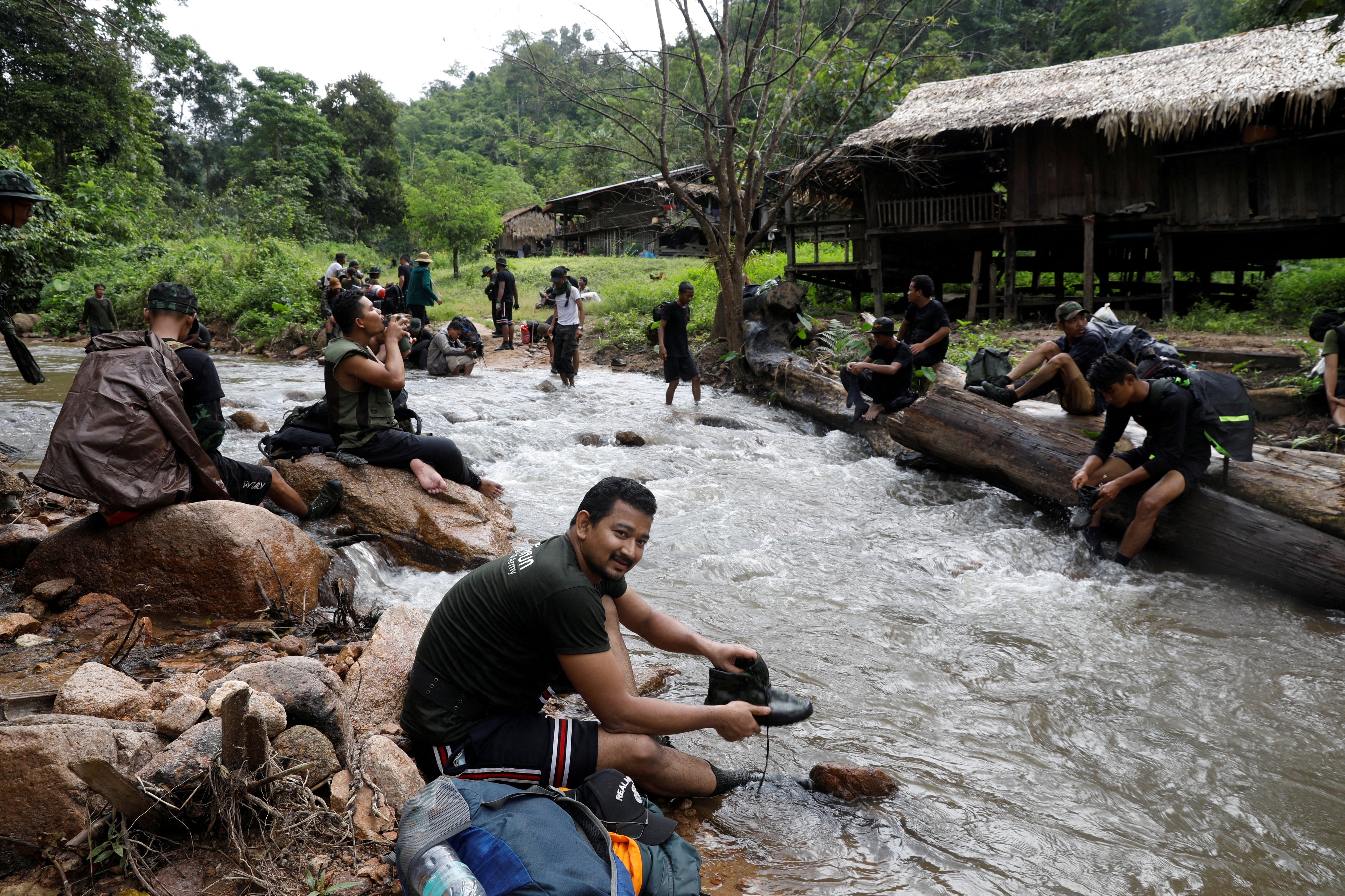 Mr Maung washes his shoes in a river