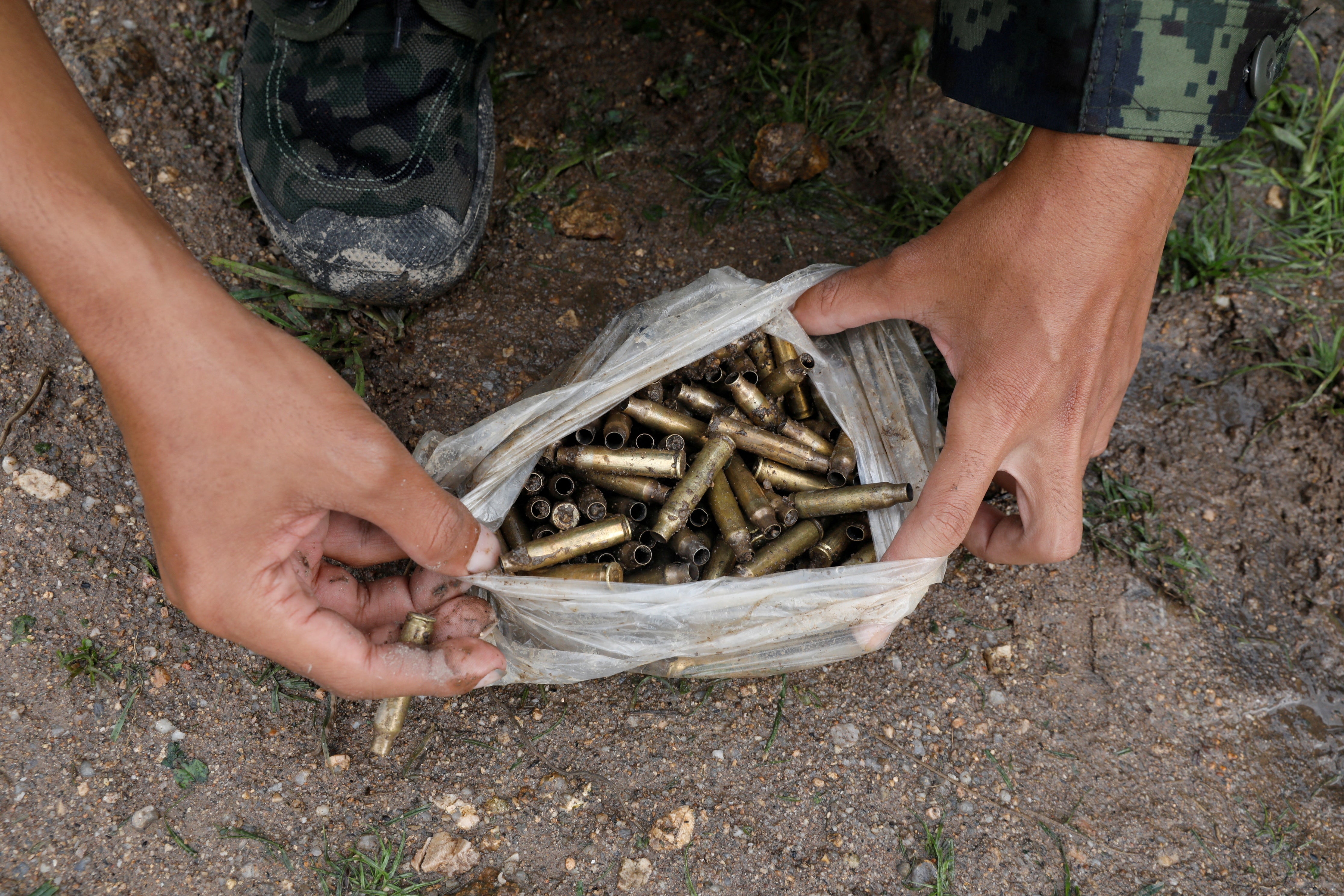 A PDF member collects spent bullet cases