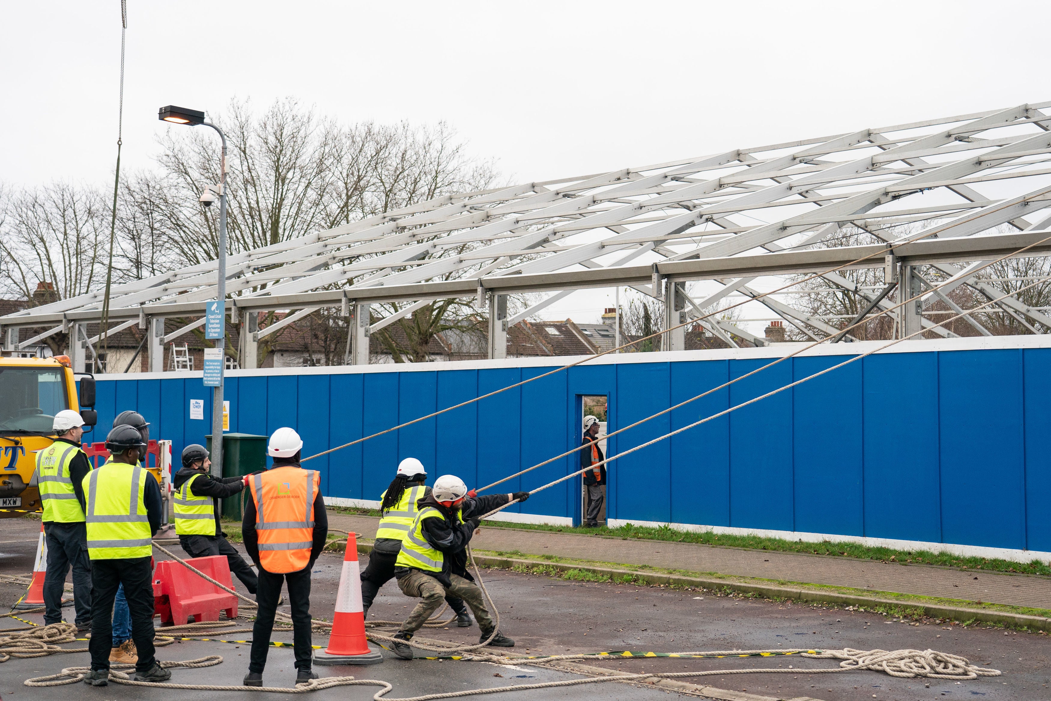 Construction workers begin building a Nightingale ‘surge hub’ at St George’s Hospital in southwest London on Thursday