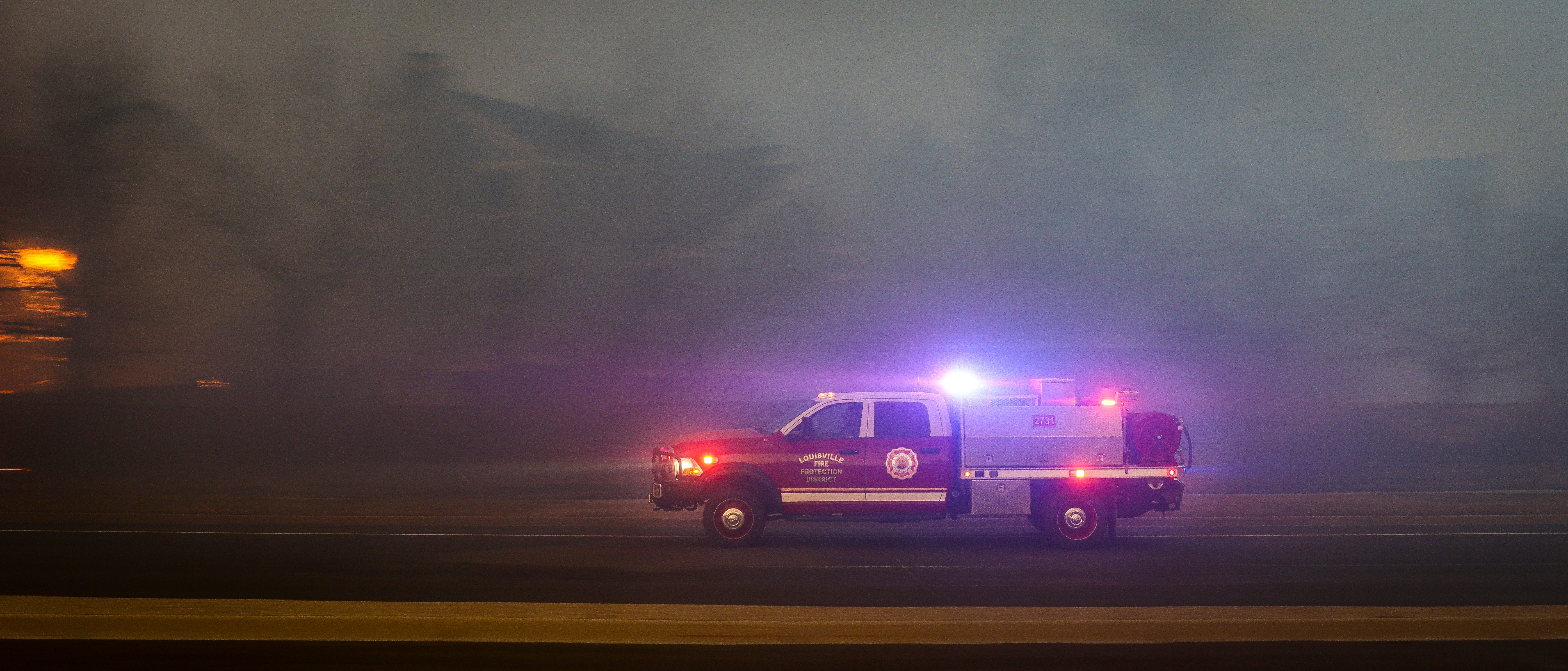 A Louisville Fire Protection District vehicle races to another hotspot in the Centennial Heights neighborhood as a fast moving wildfire swept through the neighborhood on 30 December 2021 in Louisville, Colorado