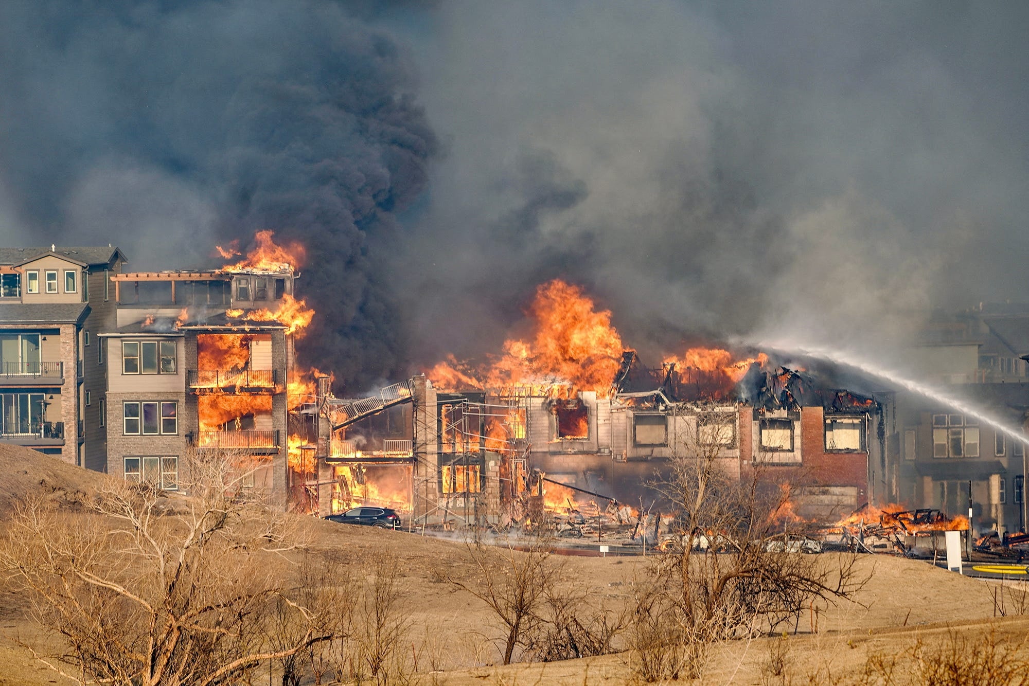 Structures burn as a wind-driven wildfire forced evacuation of the Superior suburb of Boulder, Colorado