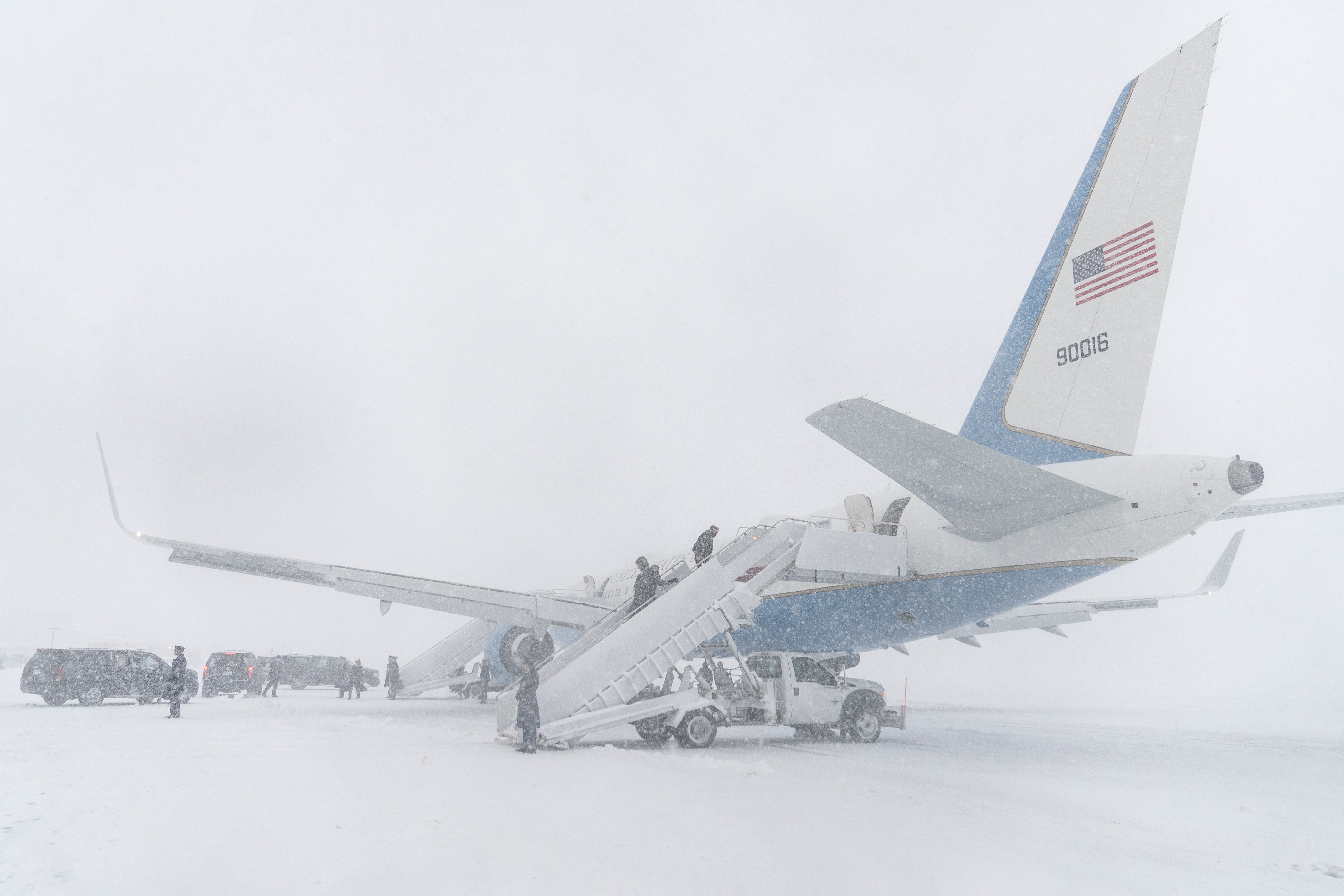 President Joe Biden's motorcade is seen on the tarmac next to Air Force One during winter snowstorm at Andrews Air Force Base, Md., Monday, Jan. 3, 2022, just before the president departs for the drive to Washington