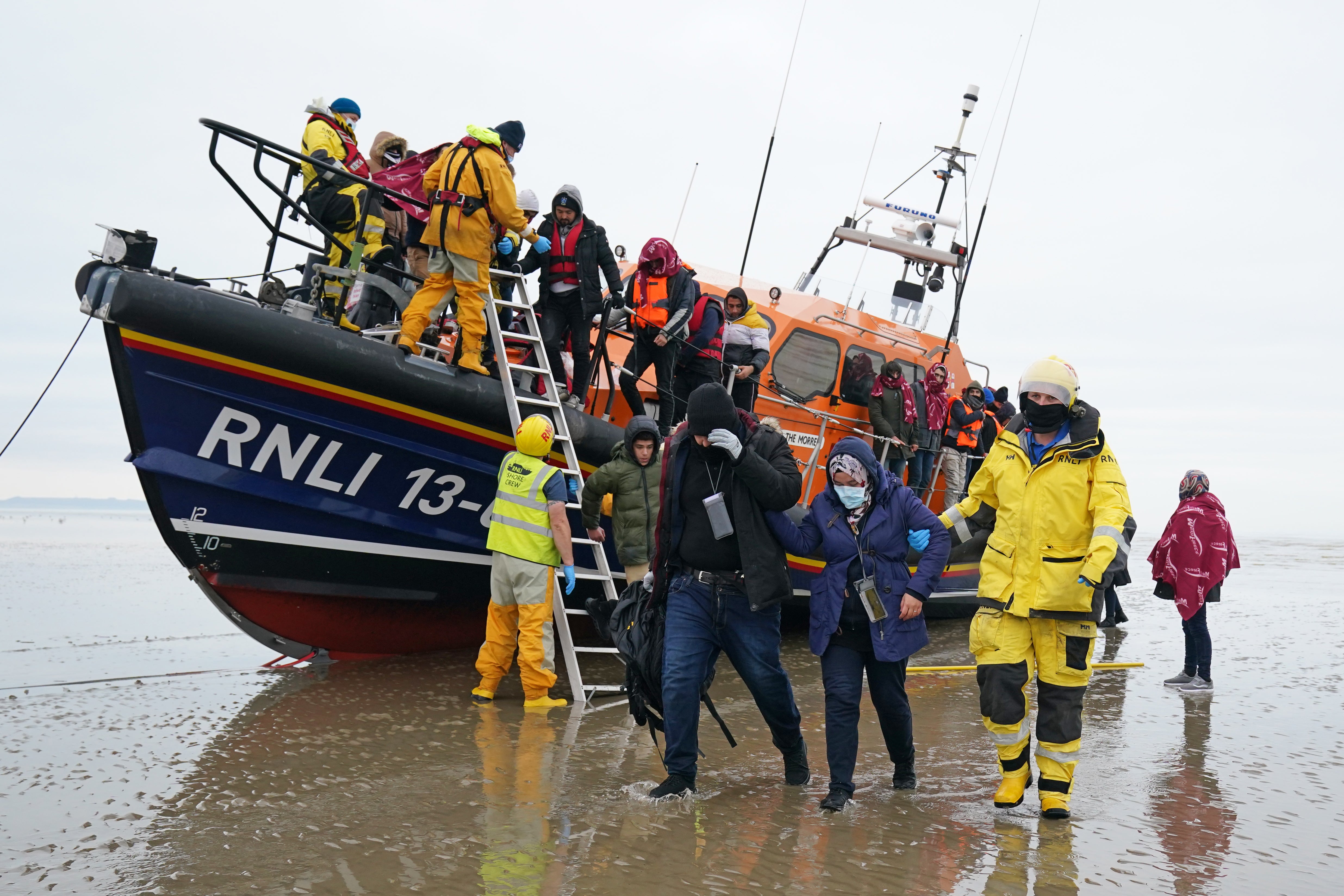 A group of people thought to be migrants are brought in to Dungeness, Kent, by the RNLI