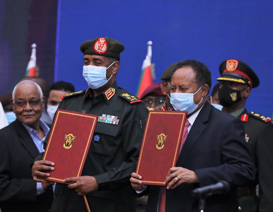 Sudan's then prime minister Abdalla Hamdok and top army general Abdel Fattah al-Burhan are seen after signing a political agreement in Khartoum, Sudan, 21 November 2021