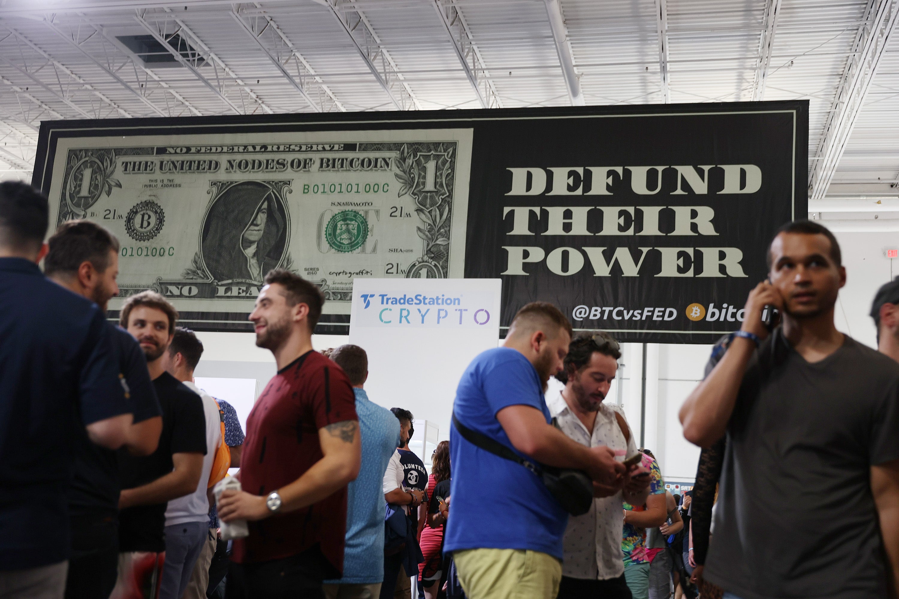 Signs above visitors to the Bitcoin 2021 conference, held in Miami