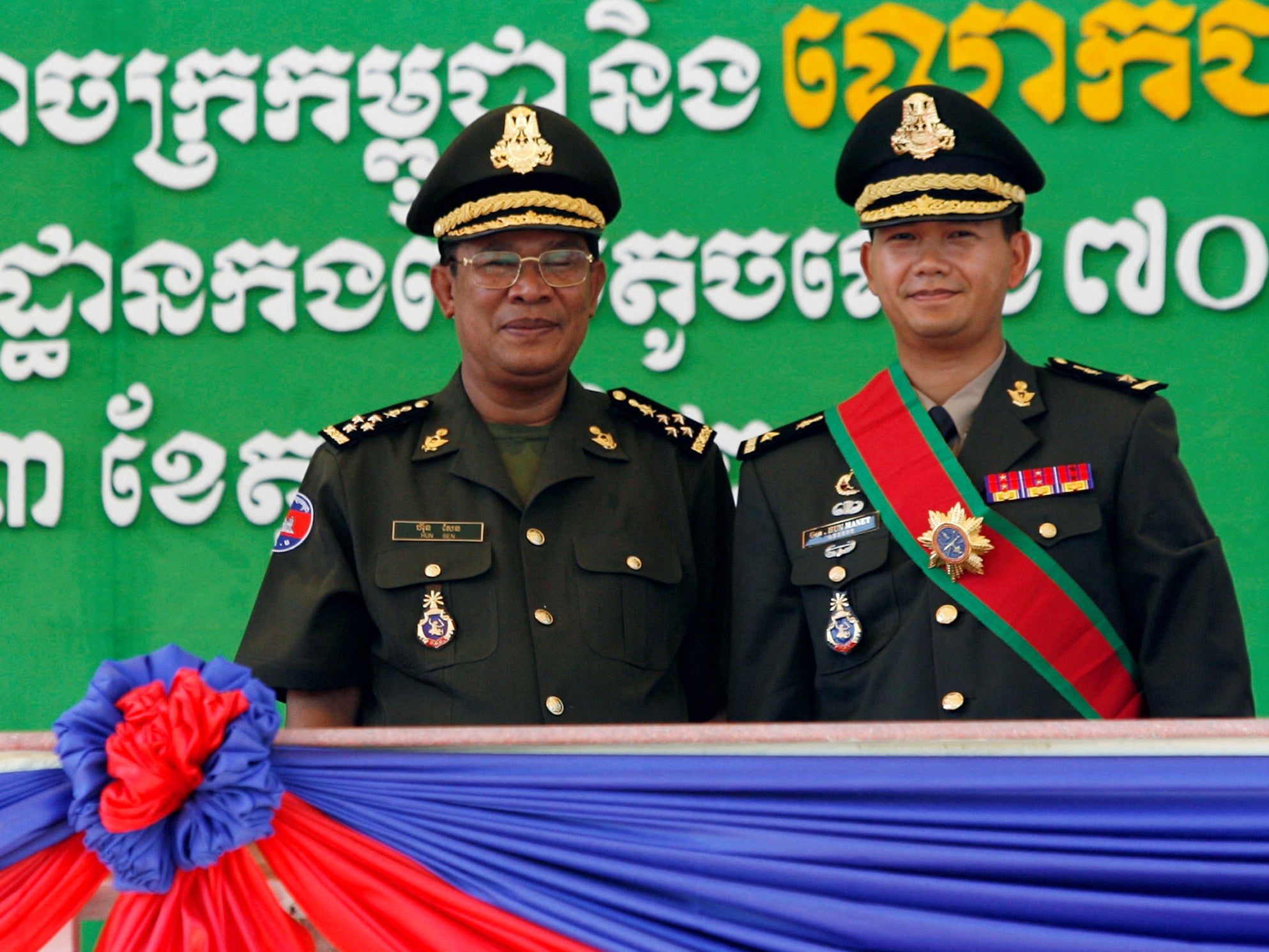 Cambodia’s prime minister, Hun Sen, left, poses with his son Hun Manet in Phnom Penh, October 2009