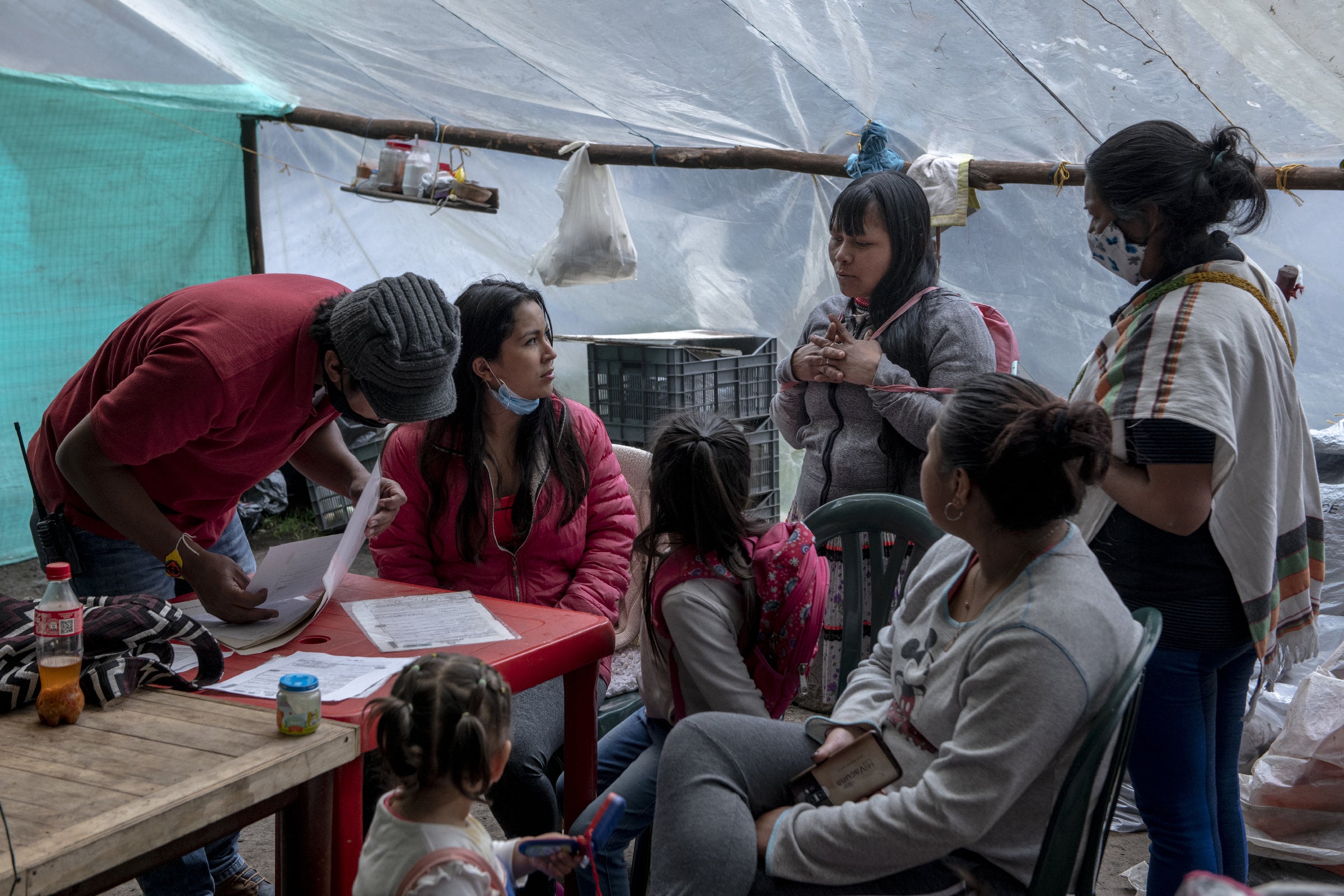 Queracama, centre right, meets representatives of the Indigenous Authorities of Bakata Association handling the transfer of her three-month-old son from the hospital to the hotel in Bogota