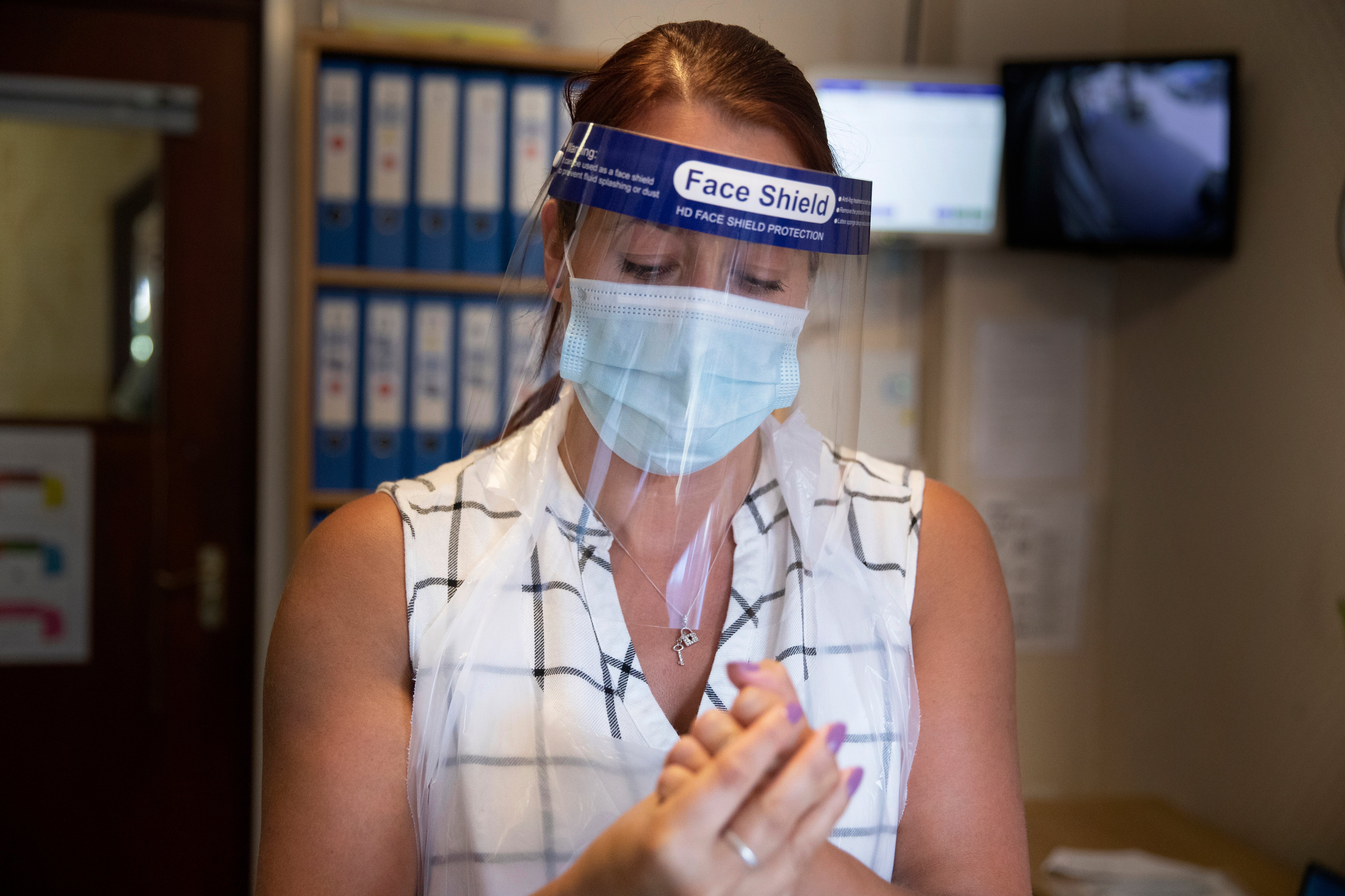 Assistant manager Claire Welford cleans her hands before conducting a coronavirus test at Eothen Homes care home in Whitley Bay, Tyneside (Owen Humphreys/PA)