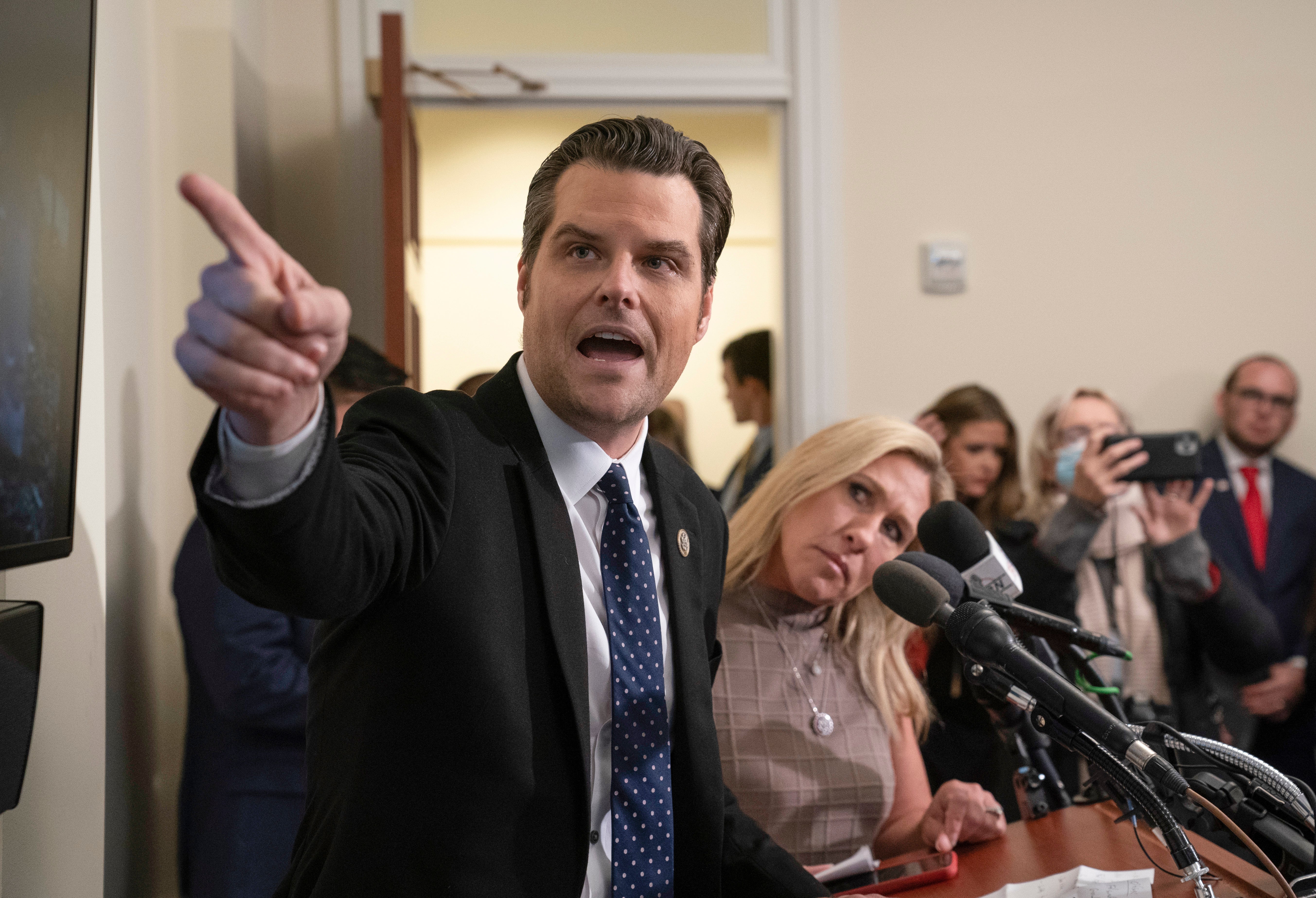 One year after the violent insurrection at the Capitol, Rep Matt Gaetz, R-FL, left, and Rep Marjorie Taylor Greene, R-GA, allies of former President Donald Trump, talk to reporters as they show a video to place responsibility on Democrats, the Capitol Police, and the federal government for the attack, on Capitol Hill in Washington. (AP Photo/J. Scott Applewhite)