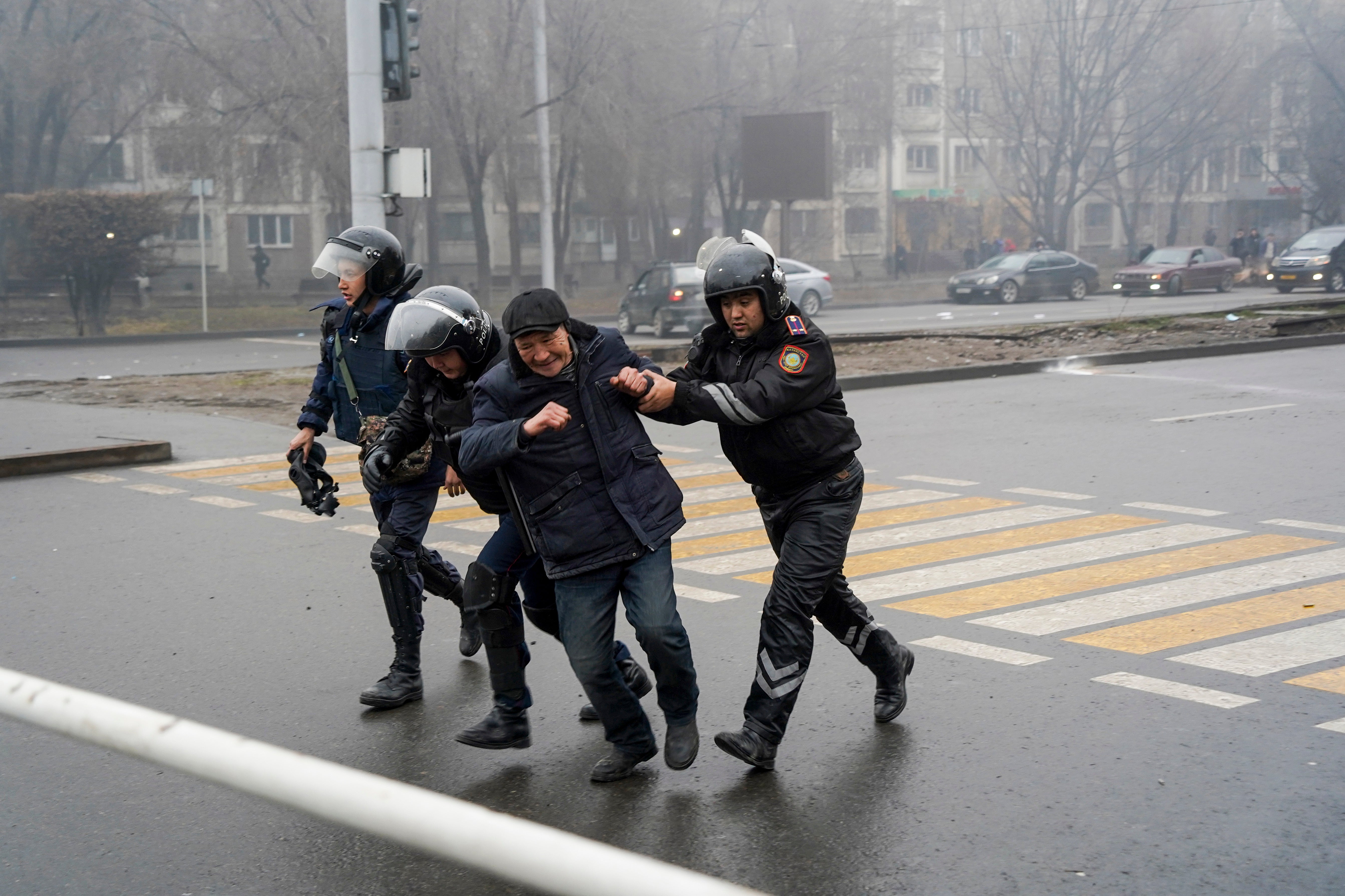 Police officers detain a demonstrator during a protest in Almaty