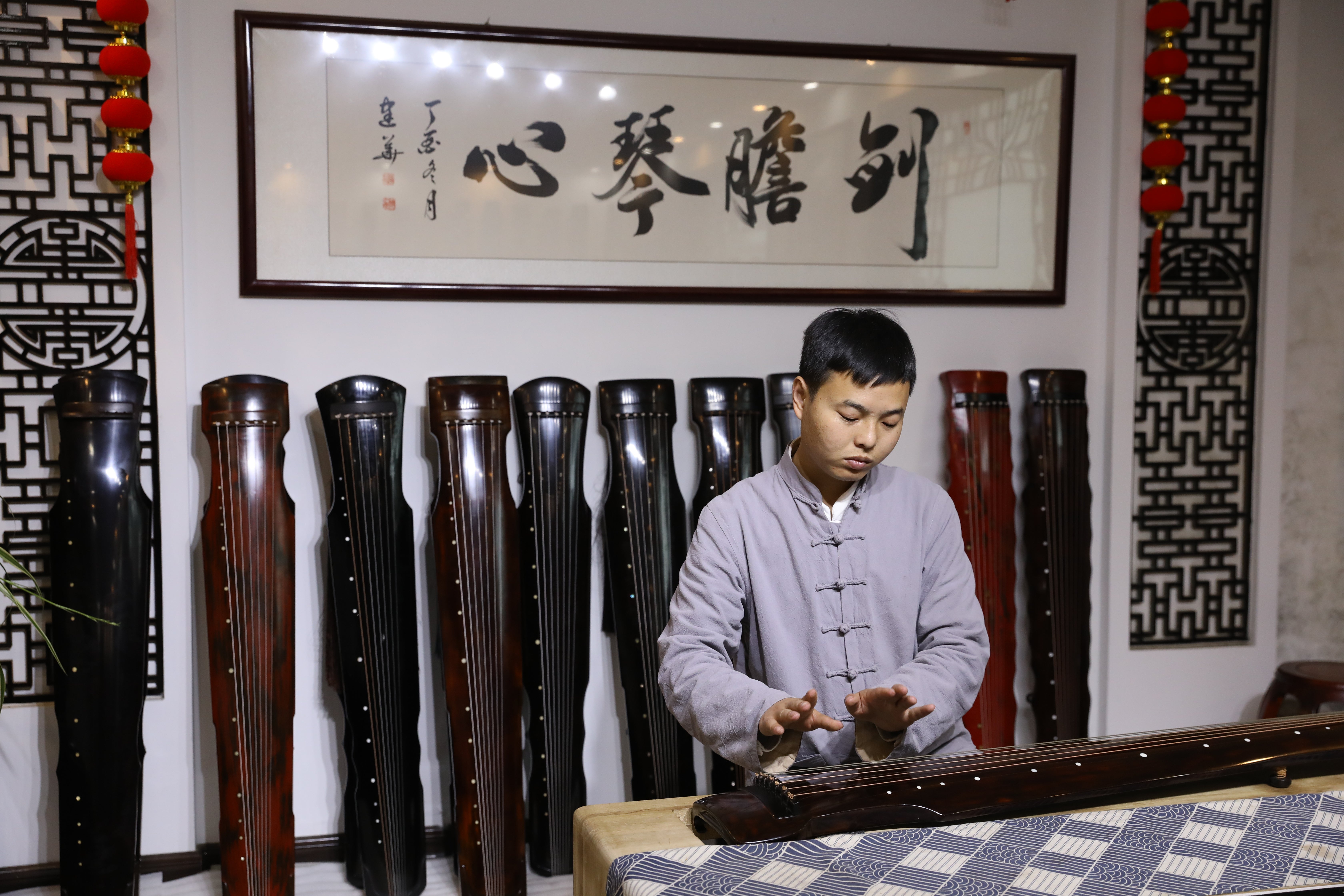 Xu Yachong plays the guqin in Xuchang village of Lankao county, Henan province