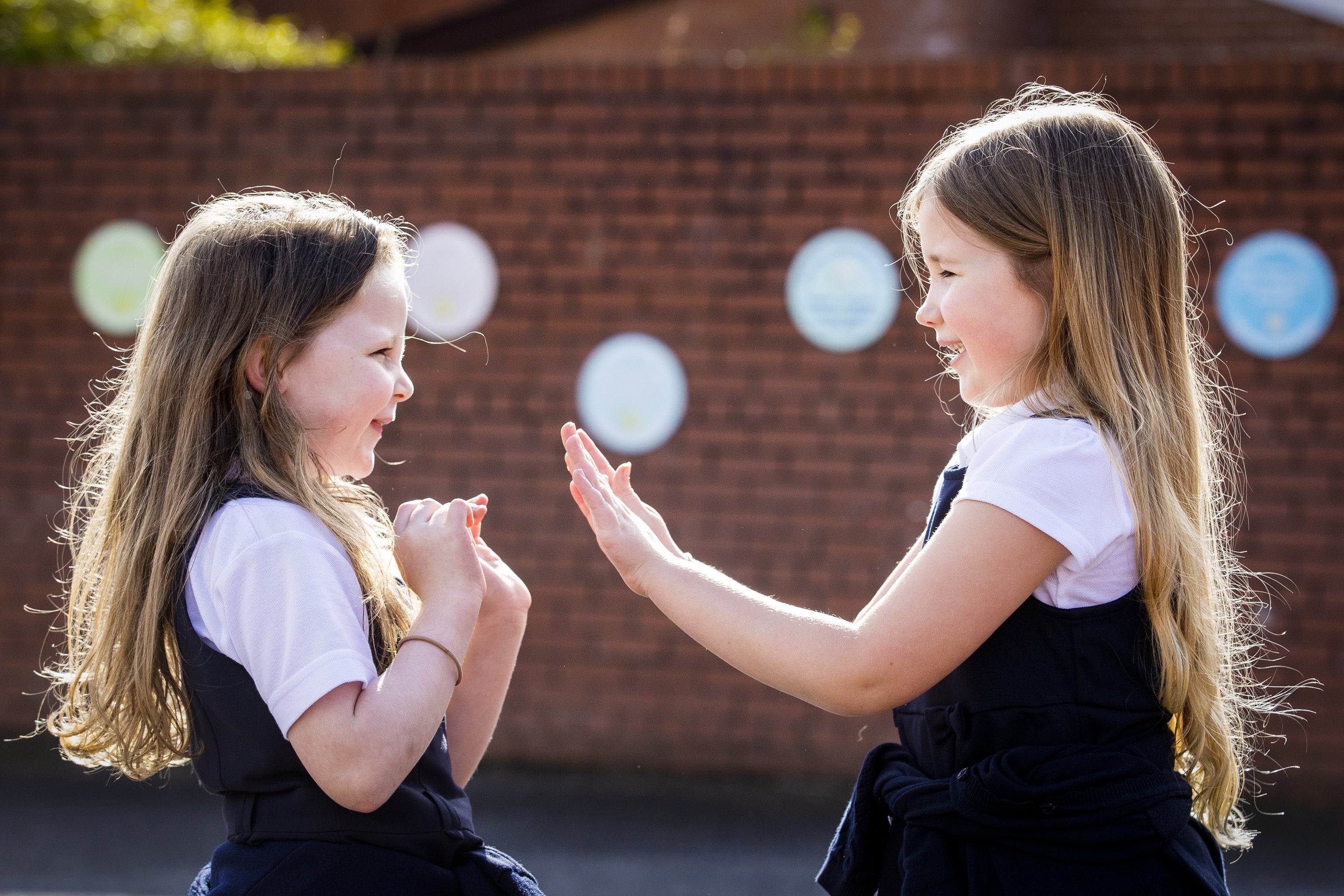 Children in the playground of Springfield Primary School in Belfast (Liam McBurney/PA)