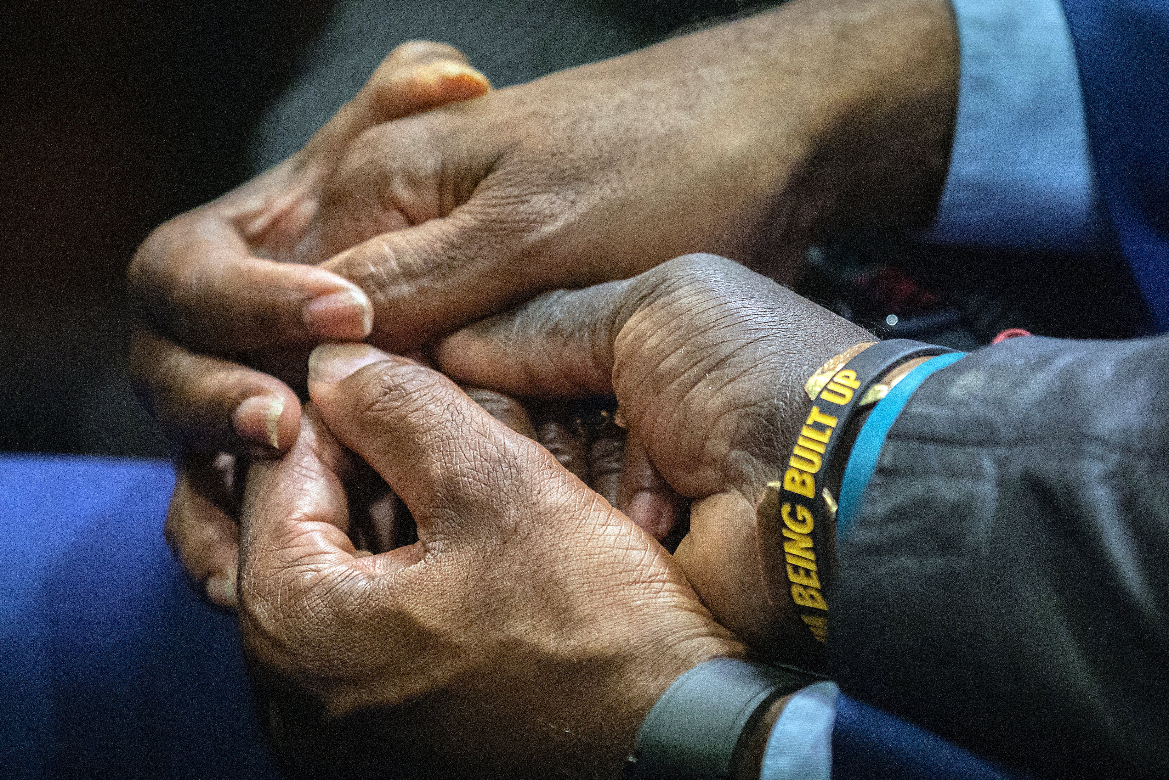 Ahmaud Arbery’s father Marcus Arbery holds hand with supporters on Friday