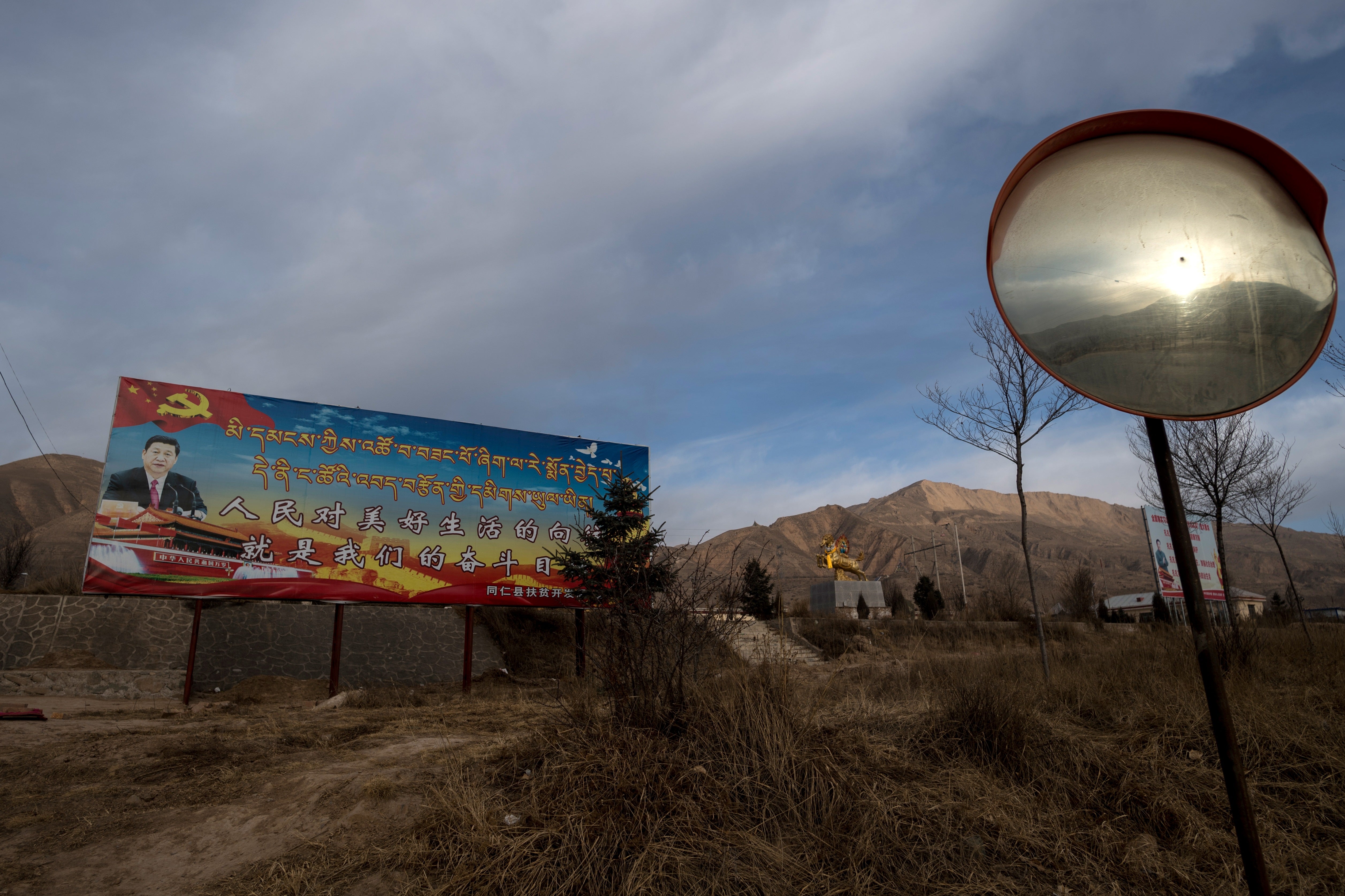 Poster showing China’s President Xi Jinping is seen next to a freeway outside of Tongren, Qinghai province on March 2, 2018