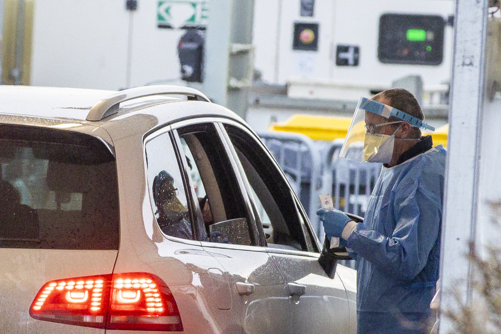 A worker at the Dundalk Stadium COVID-19 drive through test centre prepares to give a PCR test. (Liam McBurney/PA)