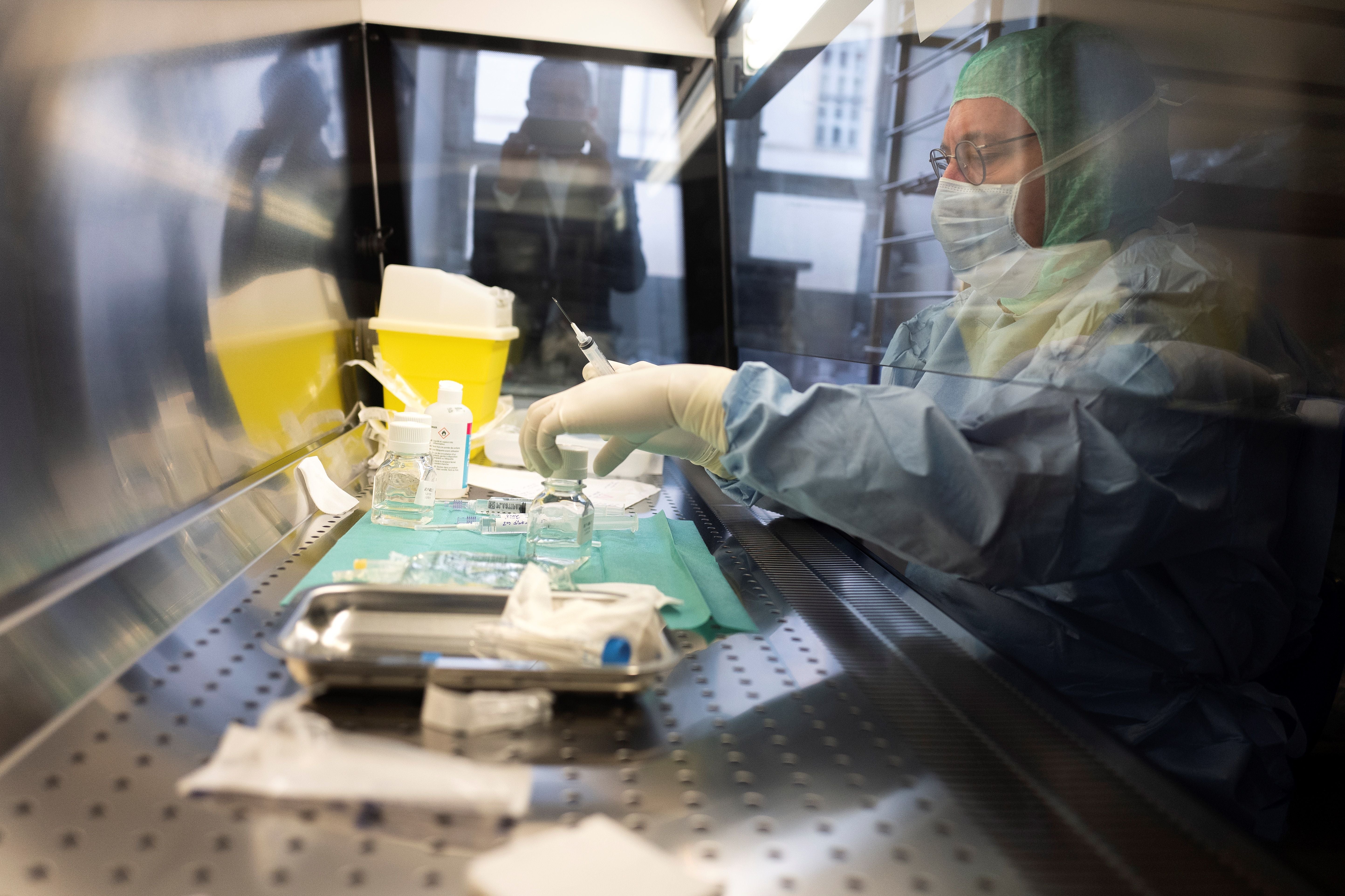 Doctor and pharmacist Gilles Leboucher prepares a diluted solution of phages at the Croix-Rousse hospital in Lyon, France