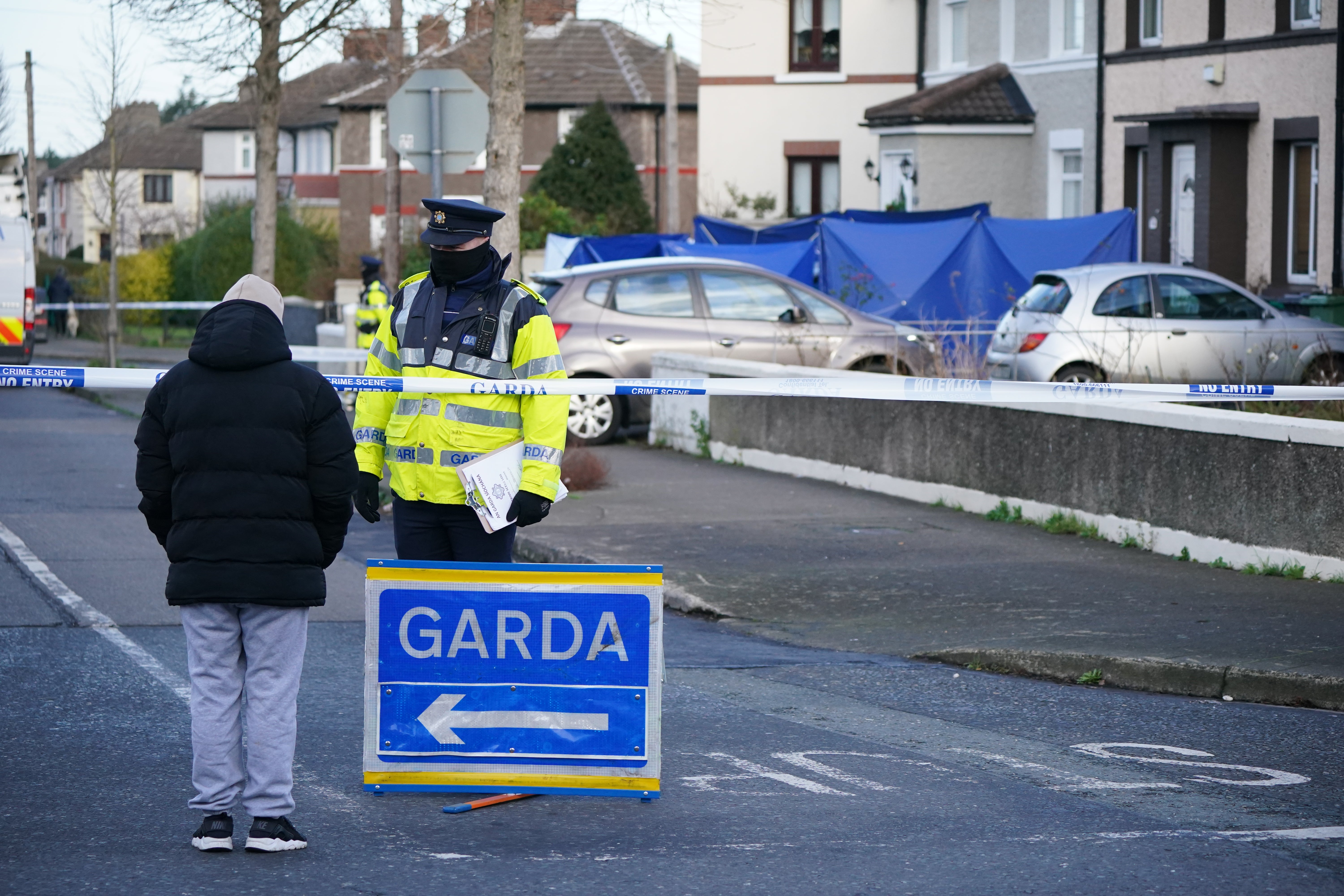 Garda at a house in the Thomond Road area of Ballyfermot, Dublin (Niall Carson/PA)