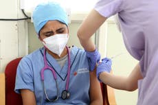 India begins booster shots and bans election rallies as Covid cases surge