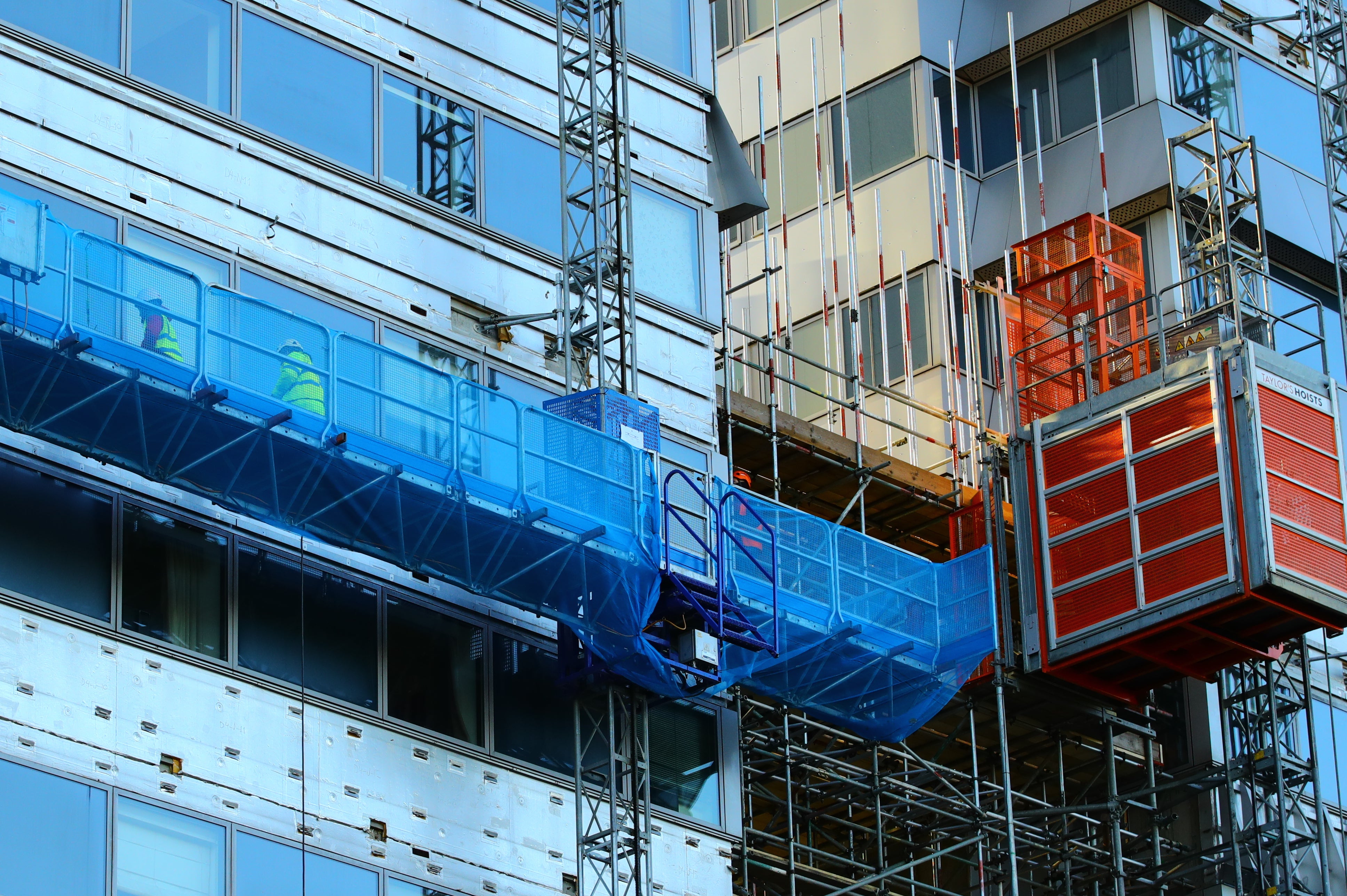 Workmen remove the cladding from the facade of a block of flats in Paddington, north London (Aaron Chown/PA)