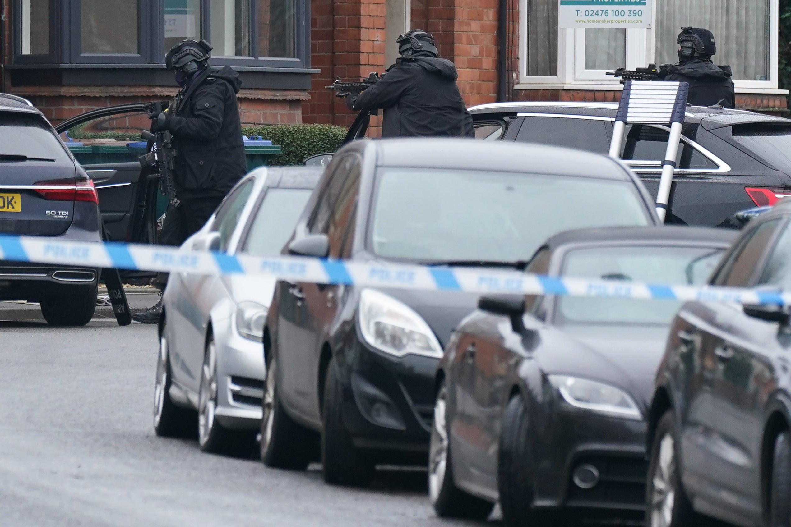 Armed police officers outside a property in Earlsdon Avenue North, Coventry (Jacob King/PA)