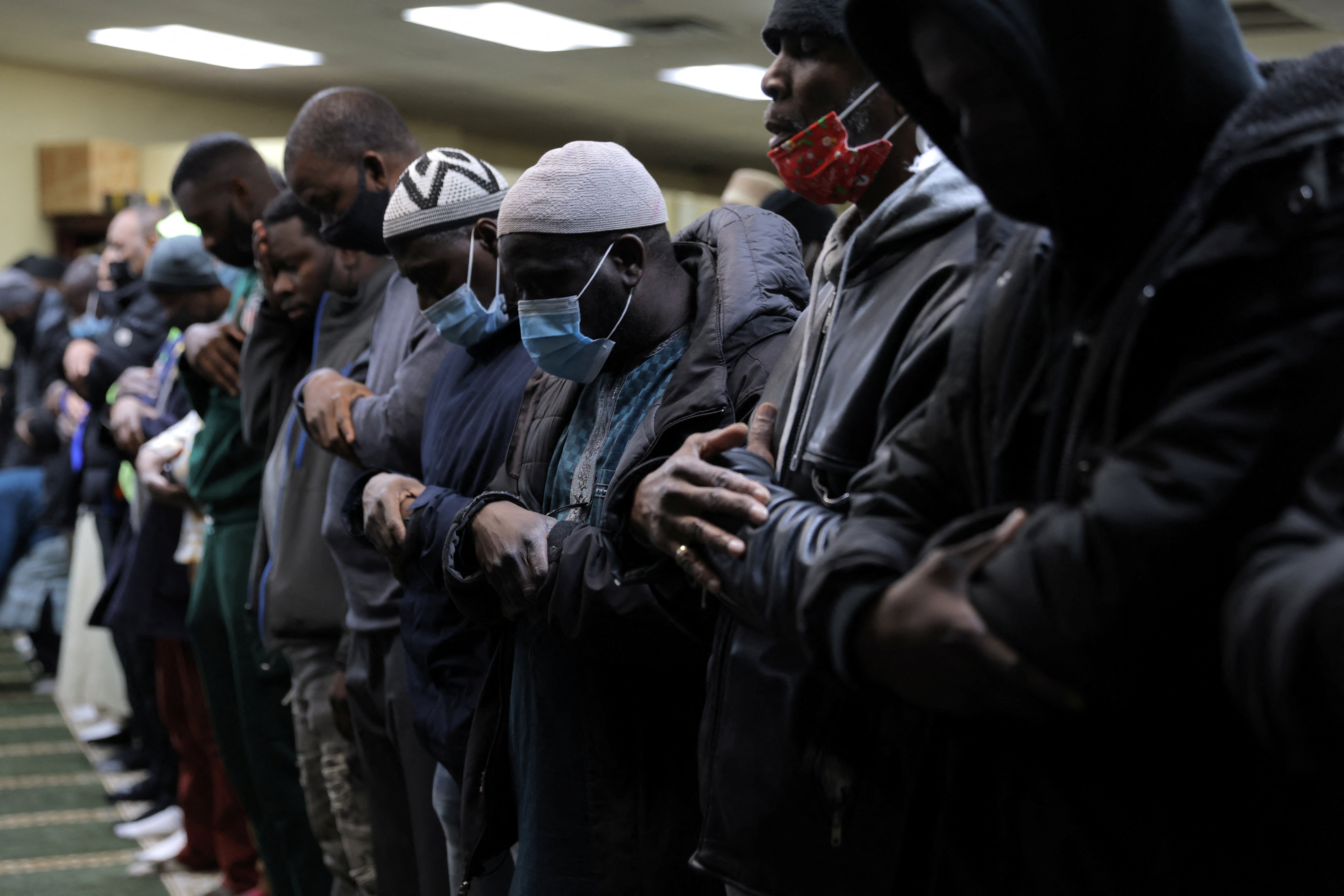 People take part in the evening prayer at the Masjid Ar Rahmah, a mosque close to the multi-level apartment building that was the scene of a fire in the Bronx