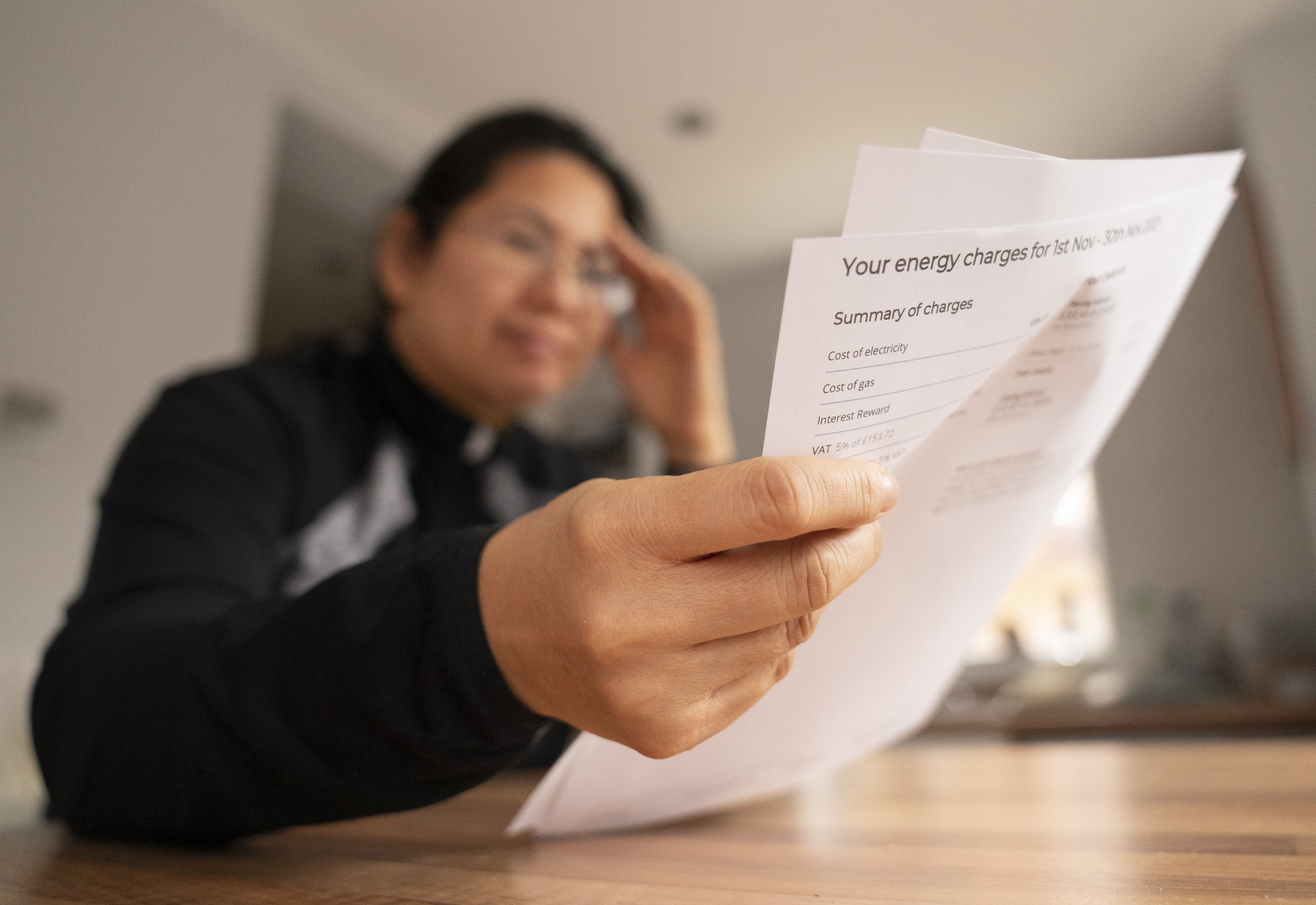 A person holding an energy bill (PA)