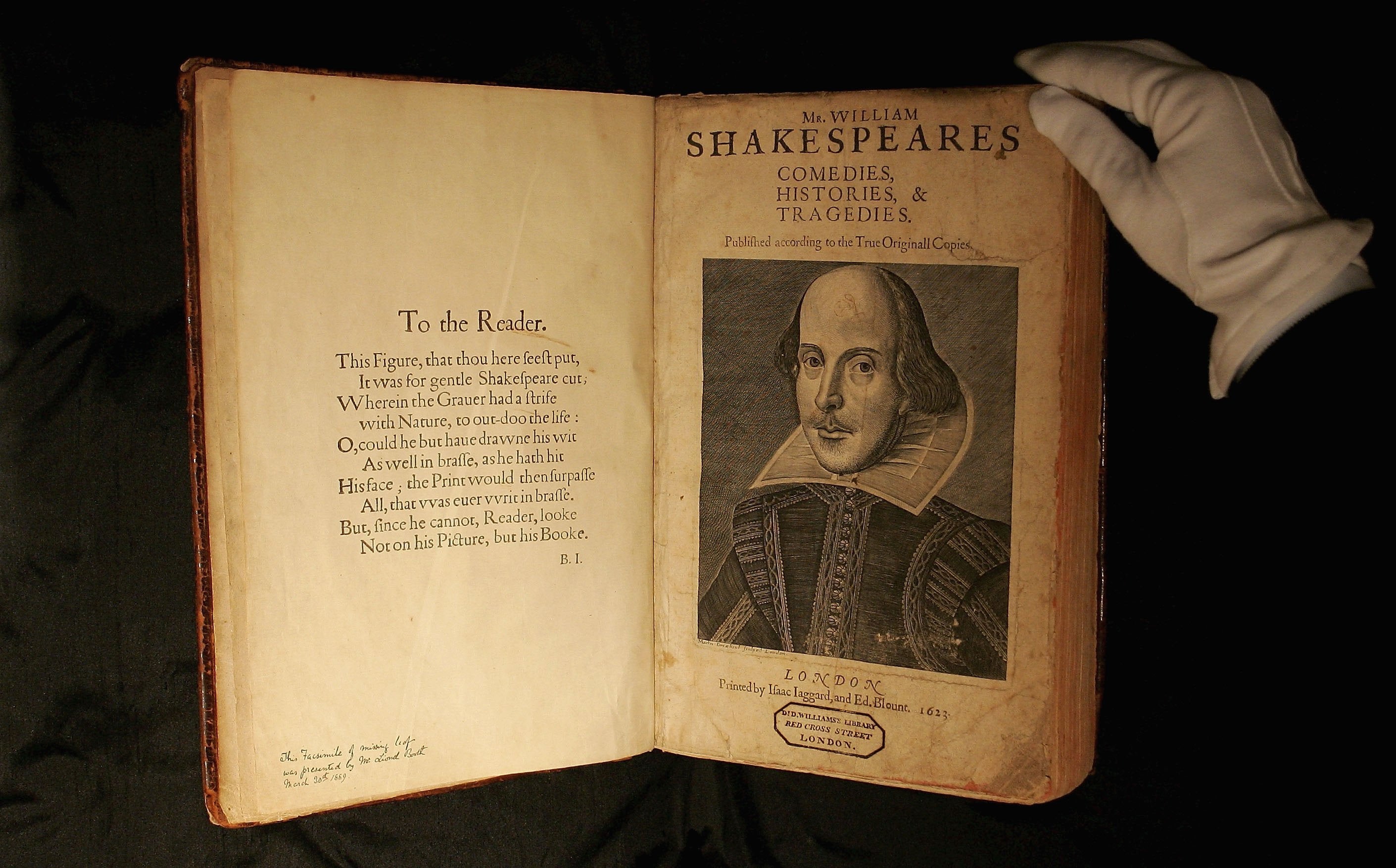 A Sotheby’s employee handles a copy of Shakespeare’s First Folio, considered the most important book in English literature