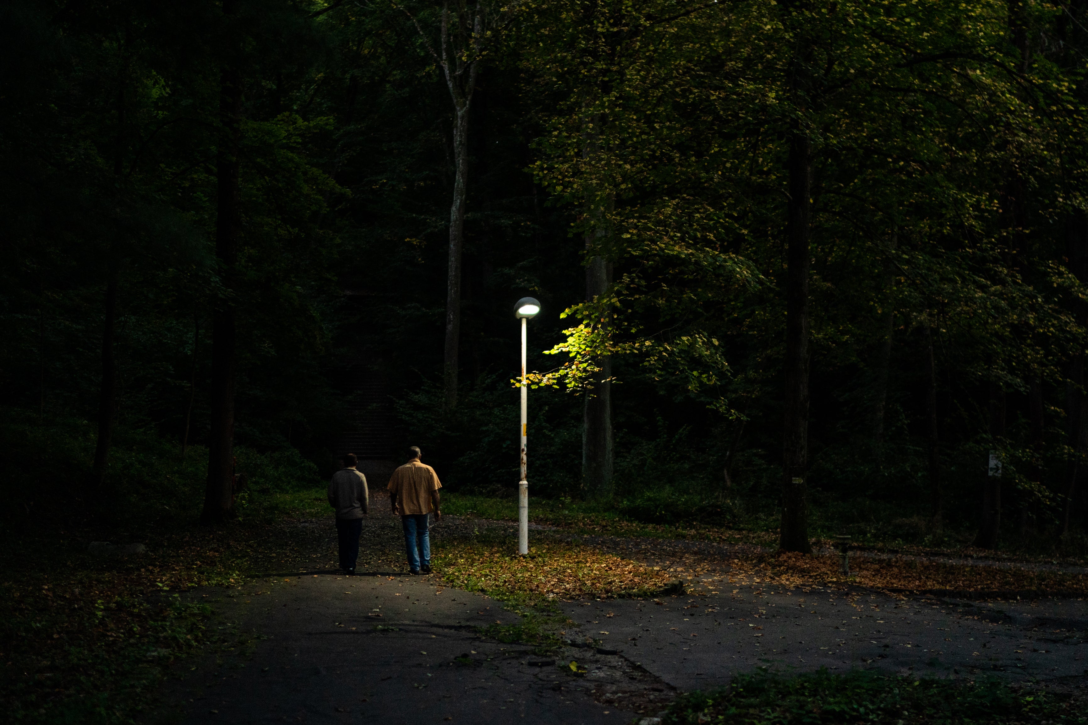 Former Guantanamo Bay detainees Hisham Bin Ali Bin Amor Sliti (right) and Hussein Salim Al-Marfadi walk through a park in Slovakia