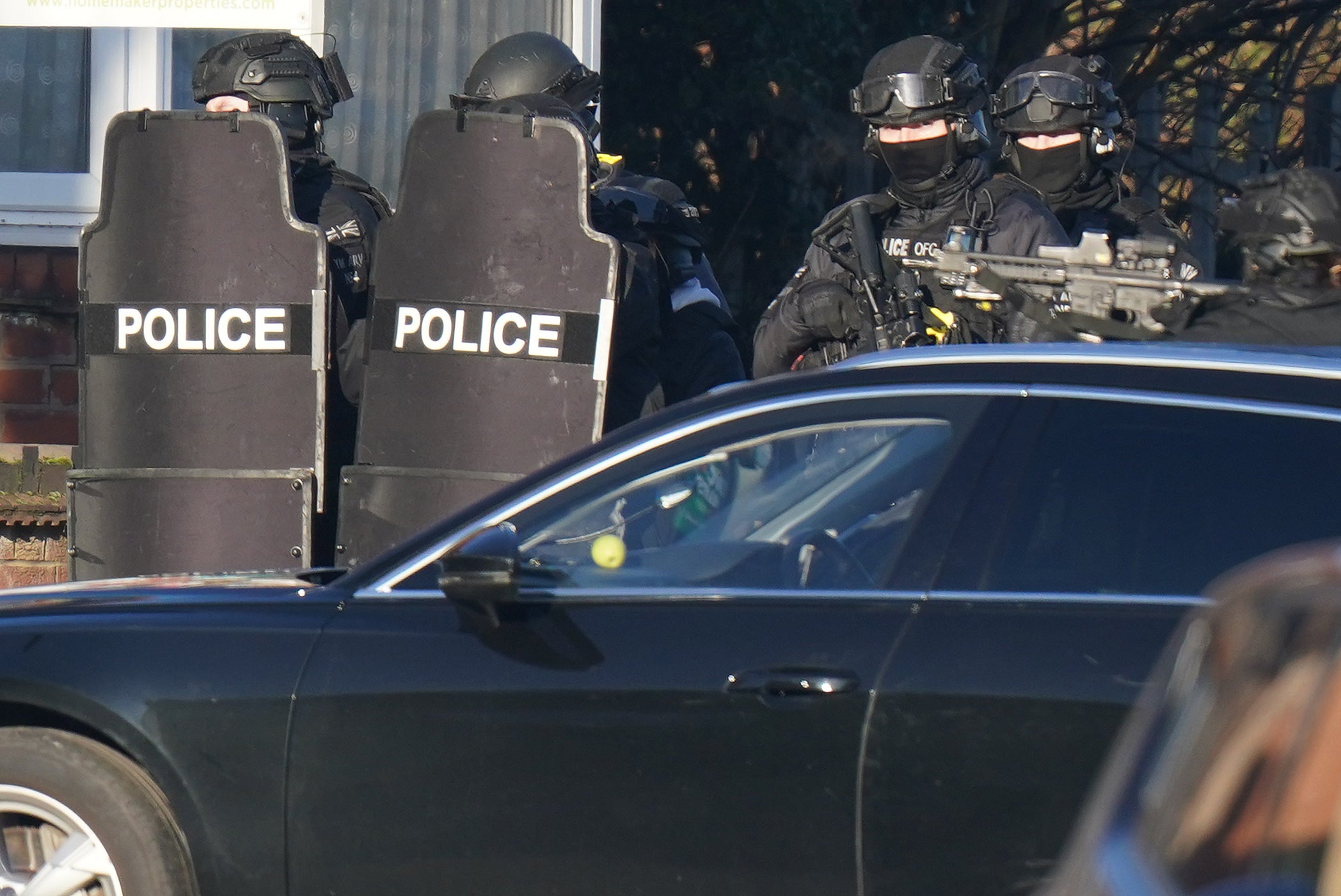 Armed police officers outside a property in Earlsdon Avenue North, Coventry, where police remain in a stand-off with a man. Officers from West Midlands Police were called to the property on Sunday to carry out a welfare check on a man and child, who are both believed to still be inside the property. Picture date: Wednesday January 12, 2022.