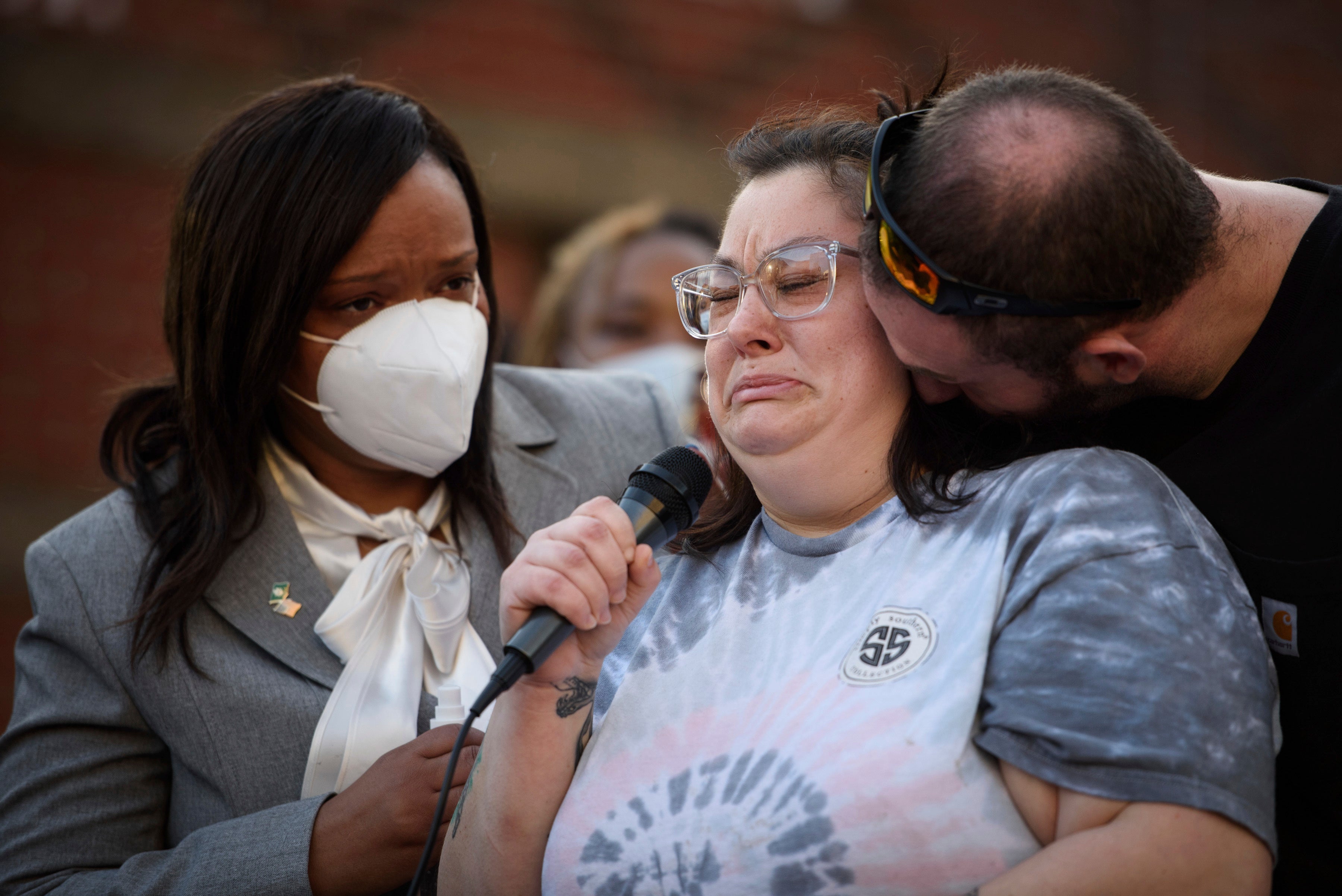 Trauma nurse Elizabeth Ricks cries as she recounts rendering aid to Jason Walker during a demonstration in front of the Fayetteville Police Department on Sunday