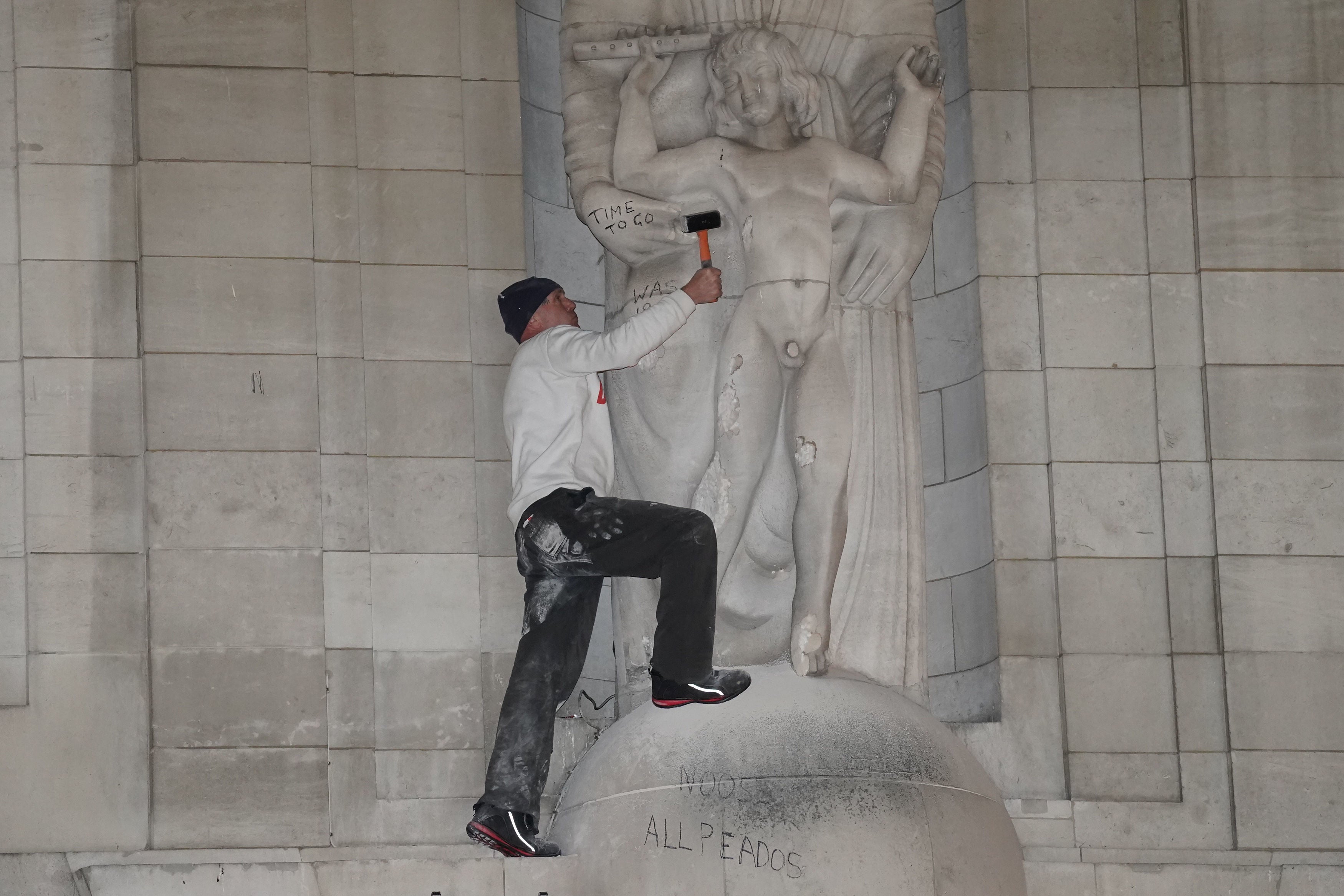 A man climbed onto the statues Prospero and Ariel from Shakespeare’s play The Tempest by the sculptor Eric Gill outside the BBC’s headquarters in central London