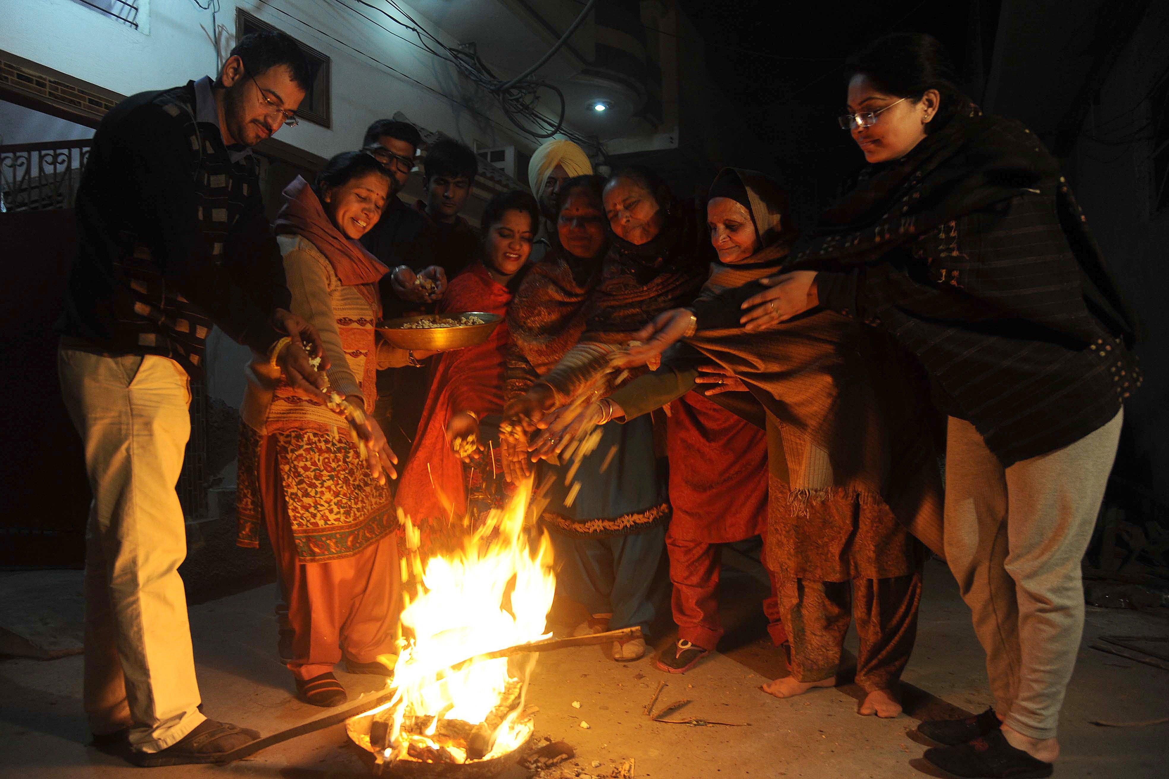 People from the Sikh community gather around a fire to celebrate the winter festival of Lohri in Punjab’s Amritsar city